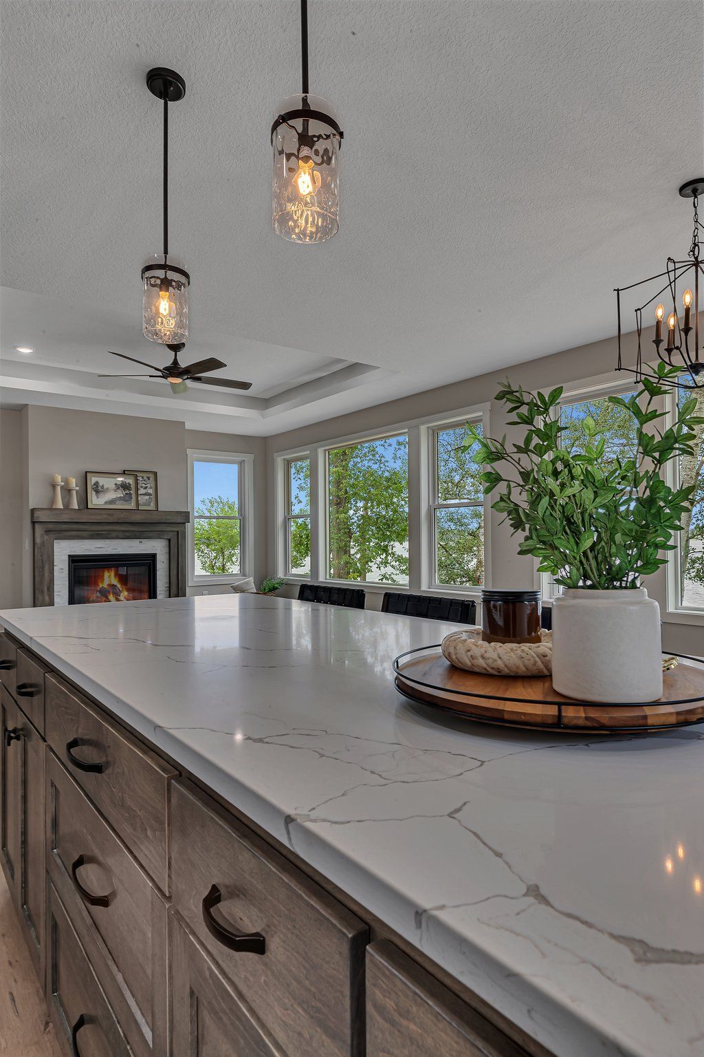 A kitchen with a large island and a fireplace.