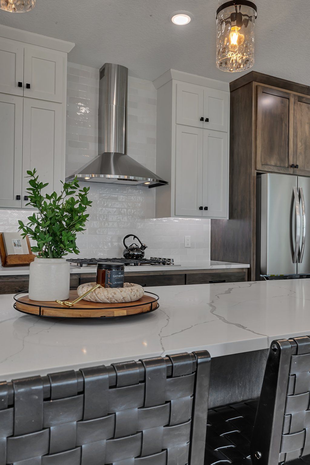 A kitchen with white cabinets and stainless steel appliances