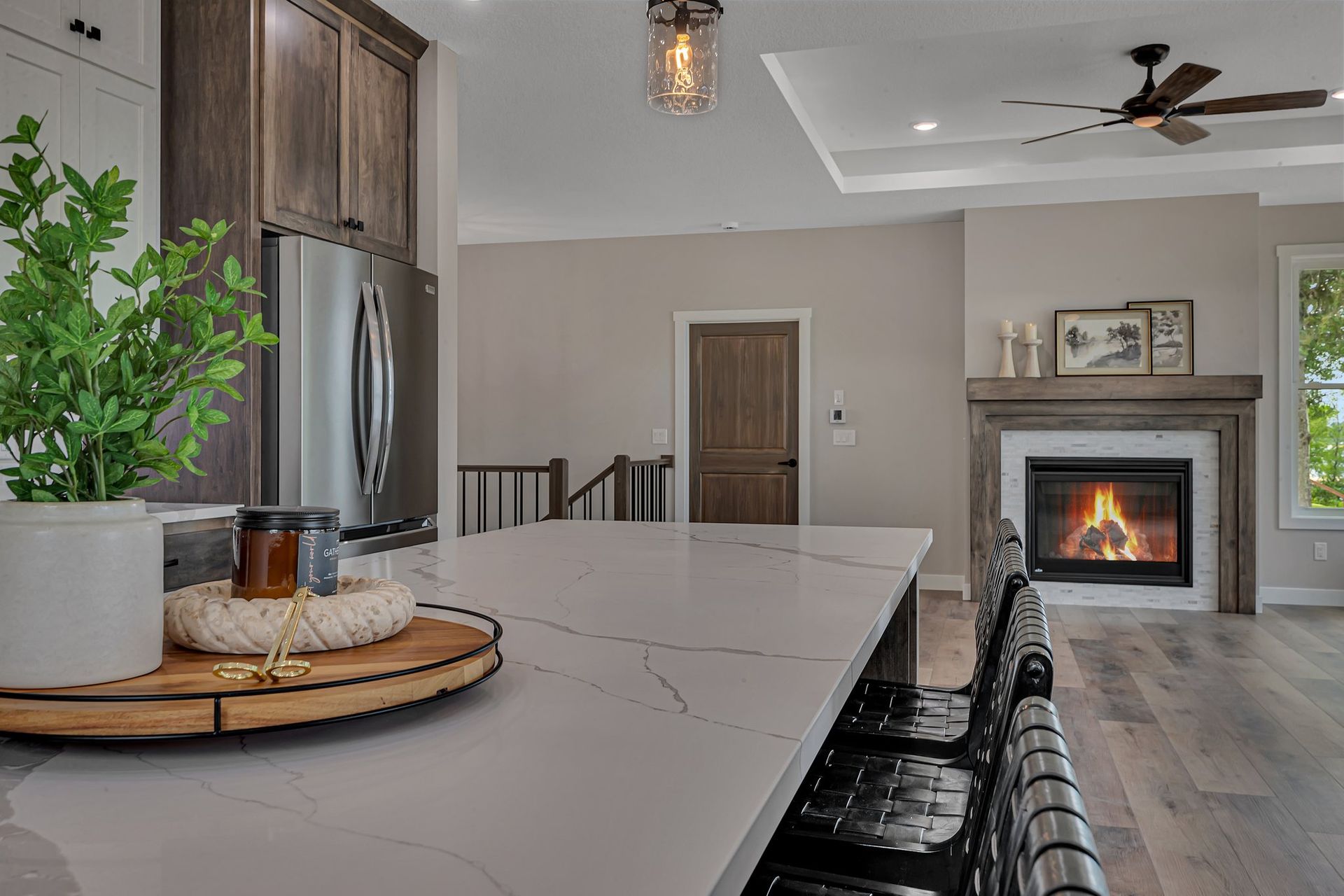 A kitchen with a large island and a fireplace.