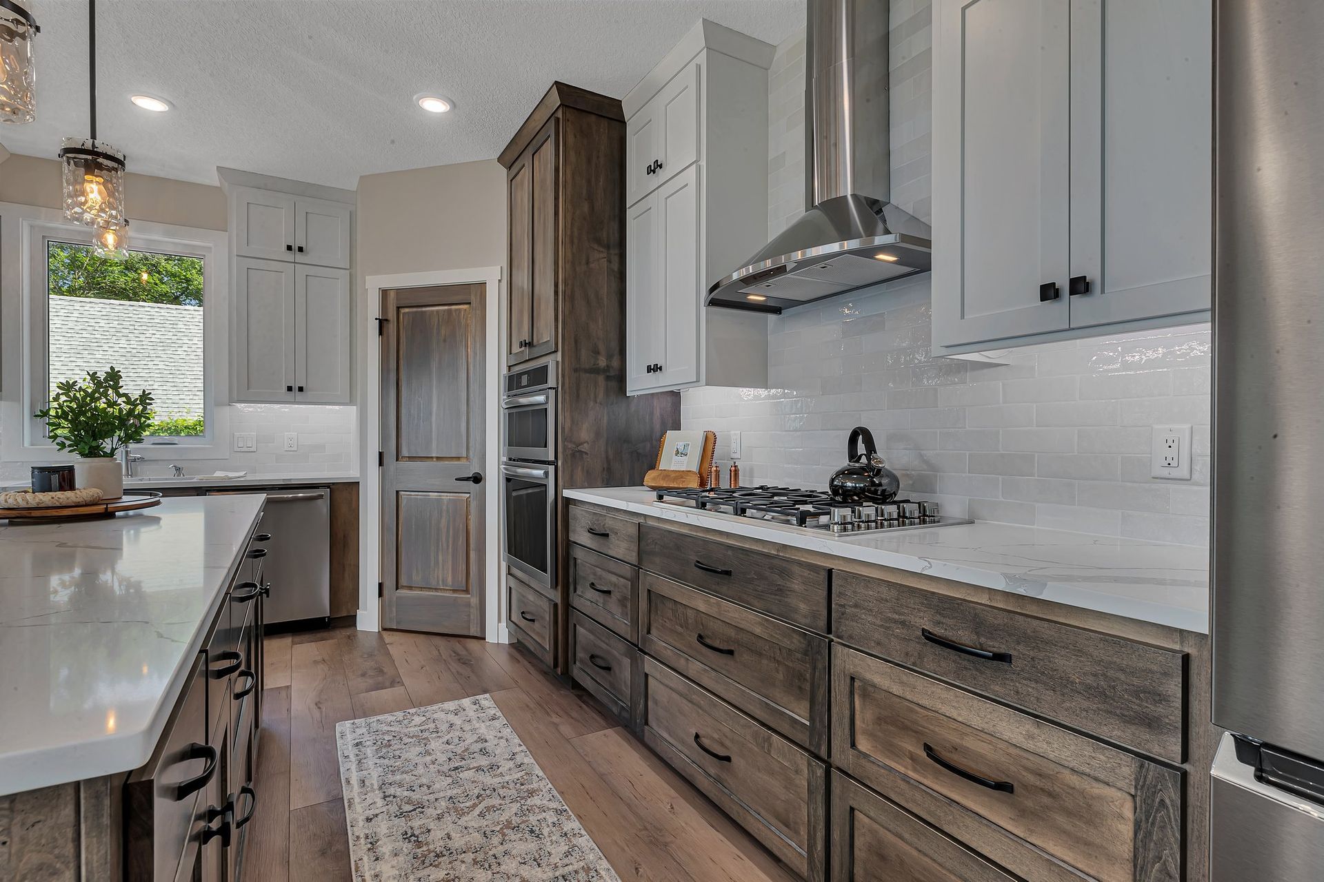 A kitchen with stainless steel appliances and wooden cabinets.