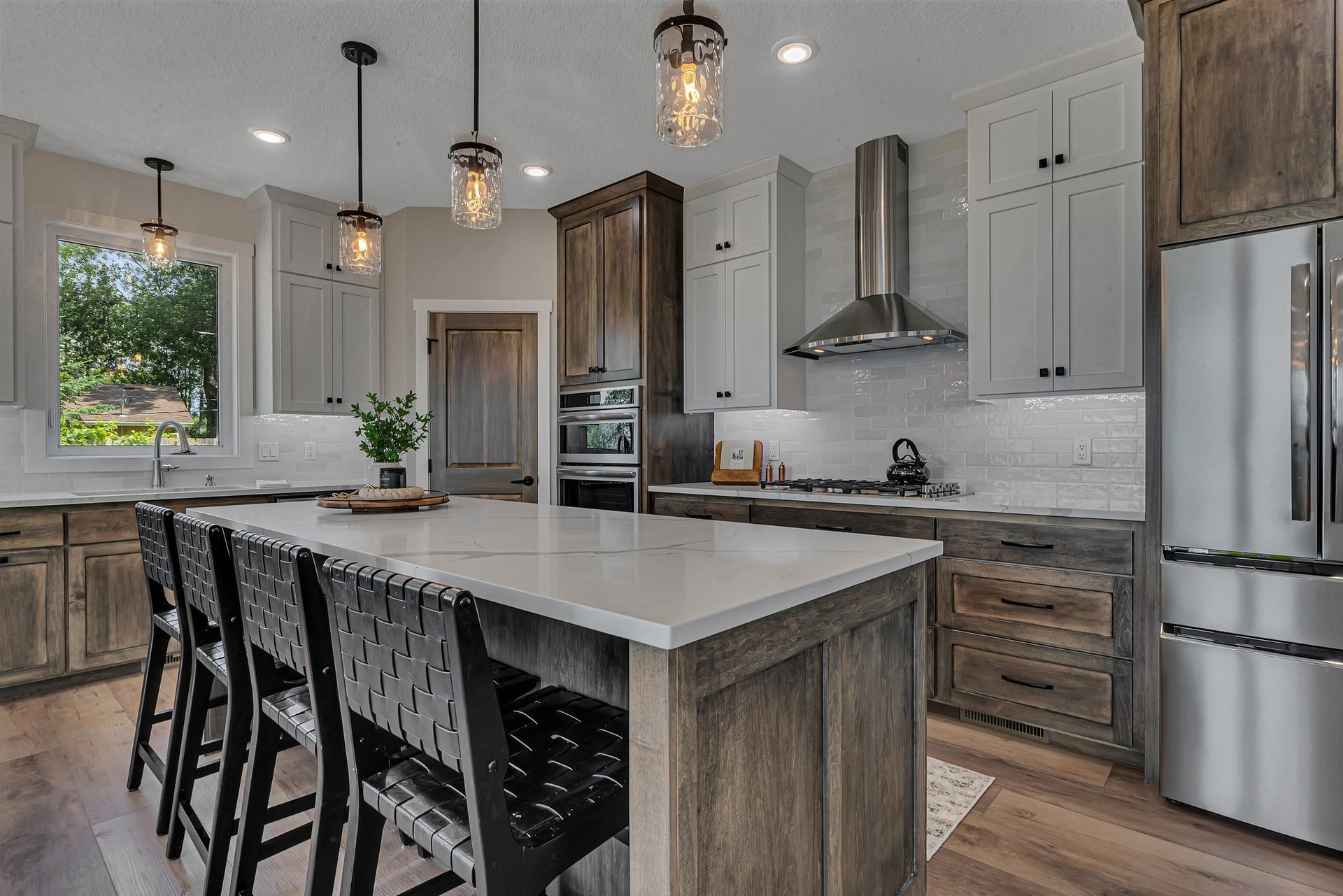 A kitchen with stainless steel appliances , wooden cabinets , and a large island.