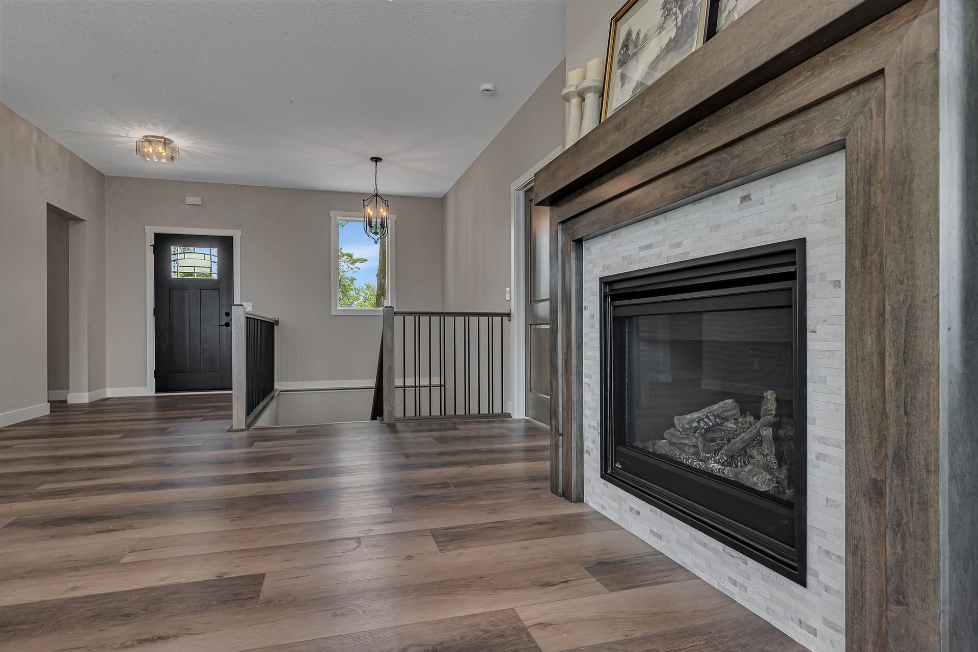 A living room with hardwood floors and a fireplace.