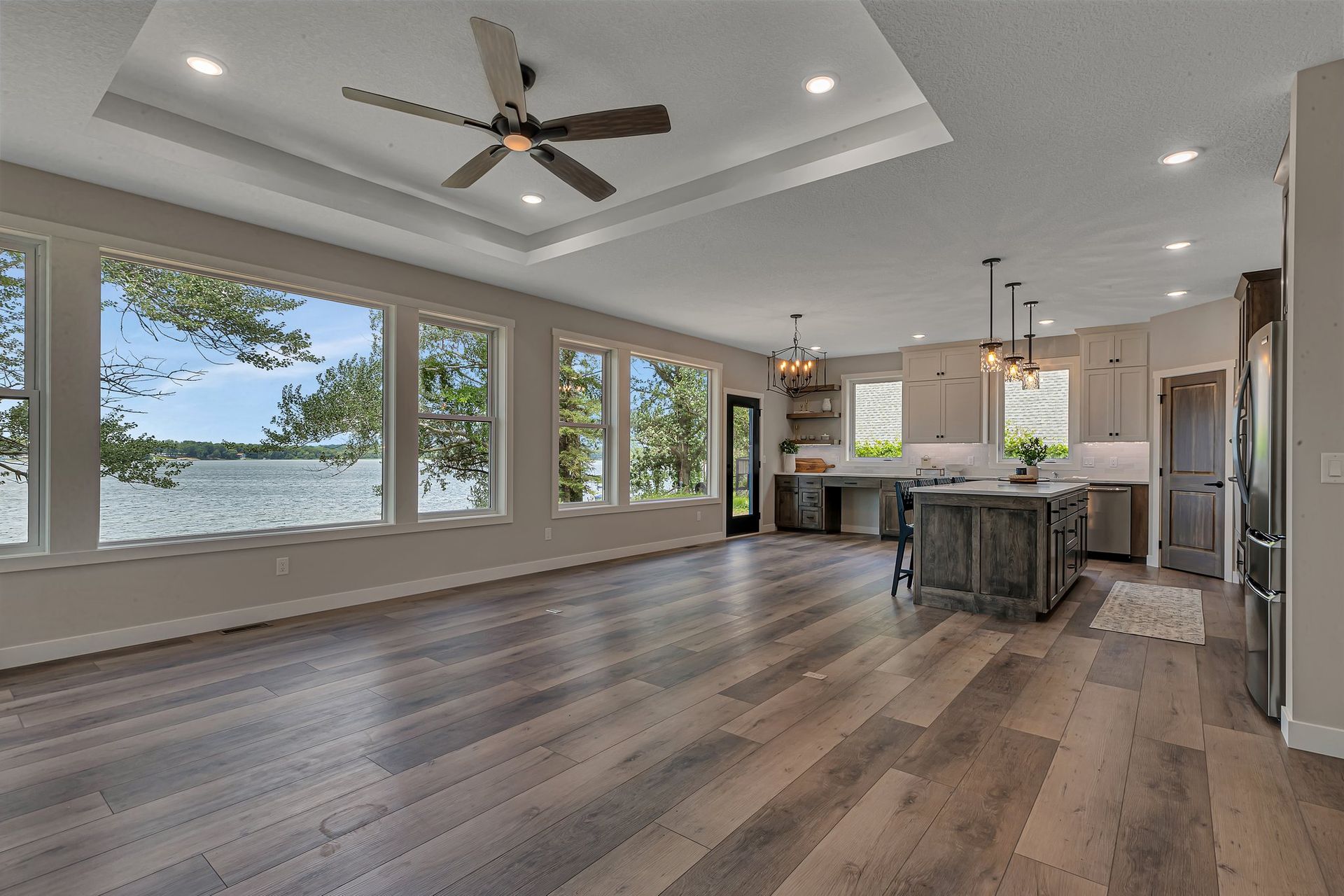 A large living room with hardwood floors and a ceiling fan.