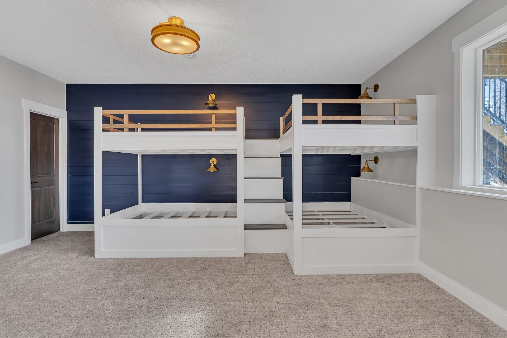 A bedroom with two bunk beds and a window.