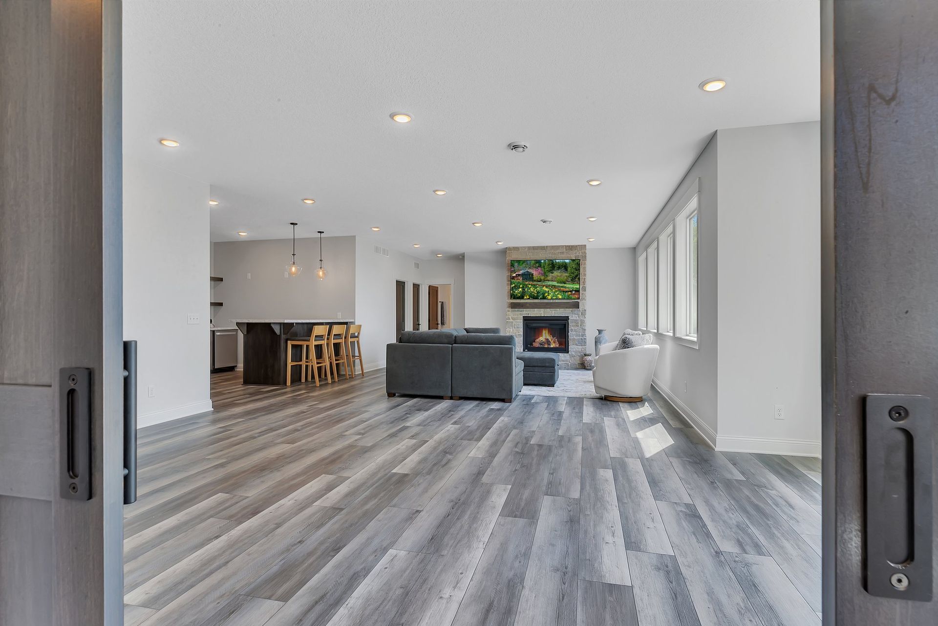 A living room with hardwood floors and a fireplace.