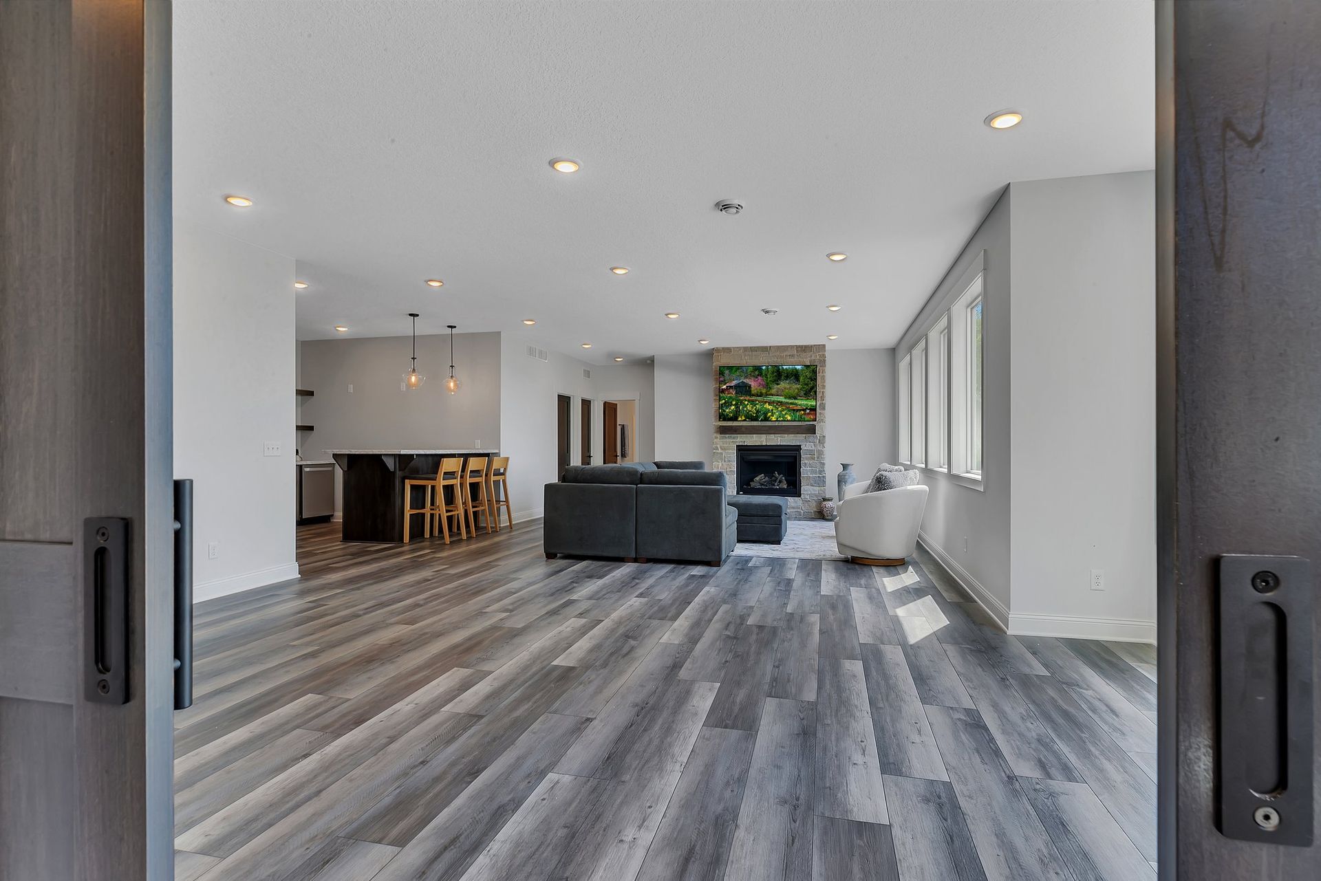 A living room with hardwood floors and a fireplace.