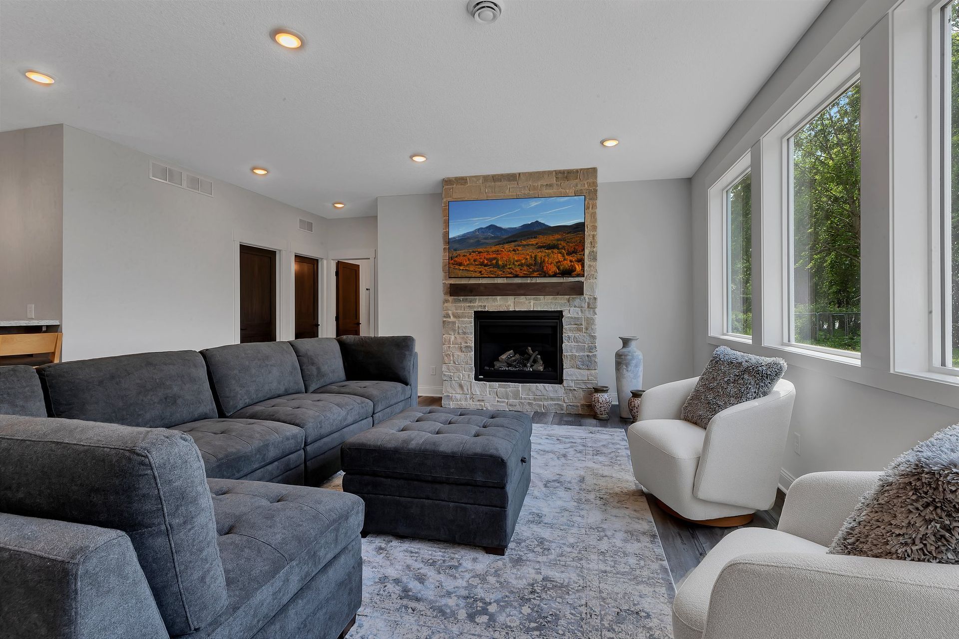 A living room with a couch , chairs , and a fireplace.
