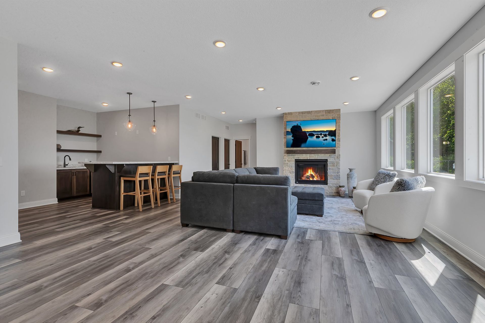 A living room with a couch , chairs , and a fireplace.