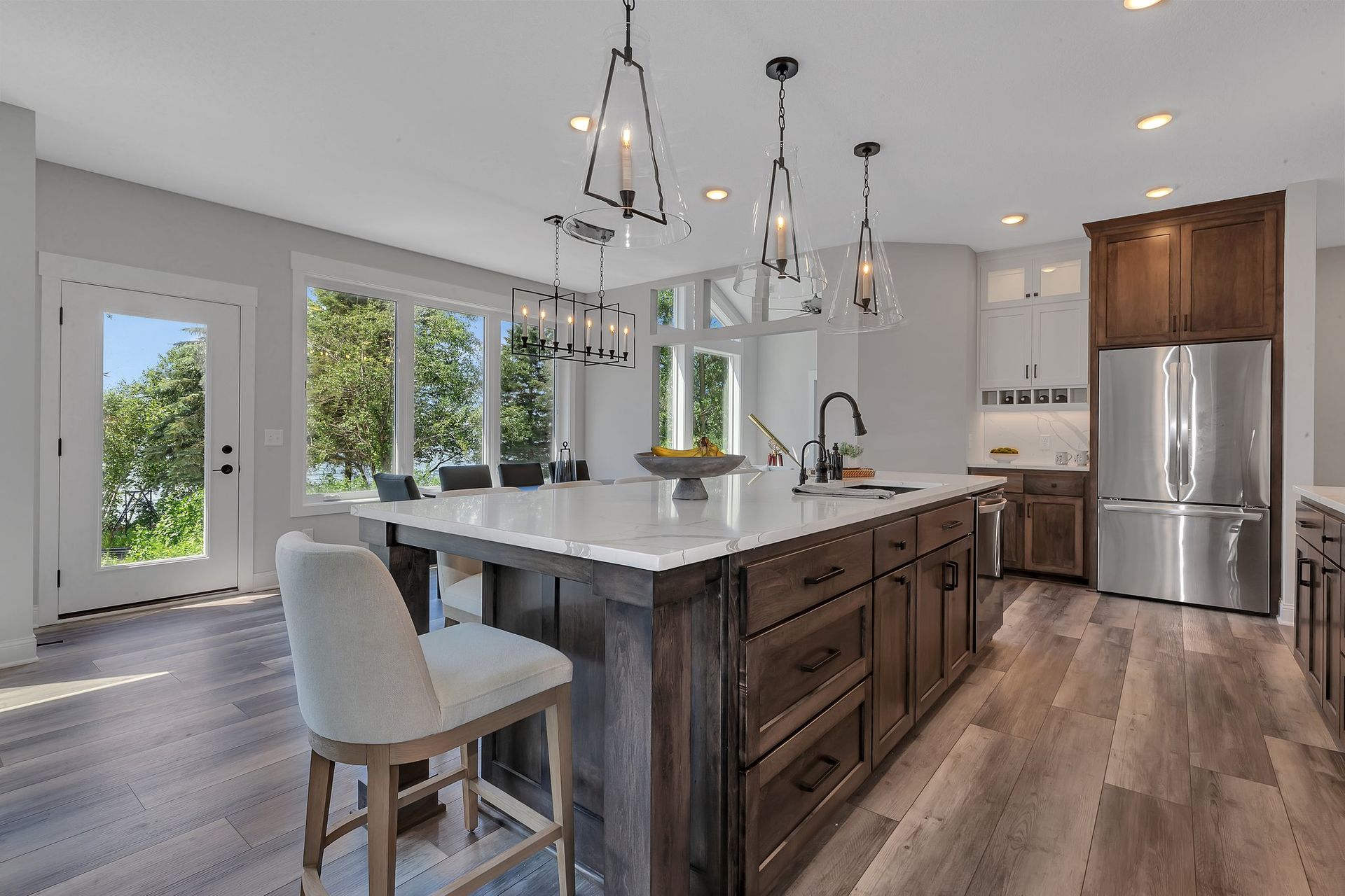A kitchen with a large island and stainless steel appliances.