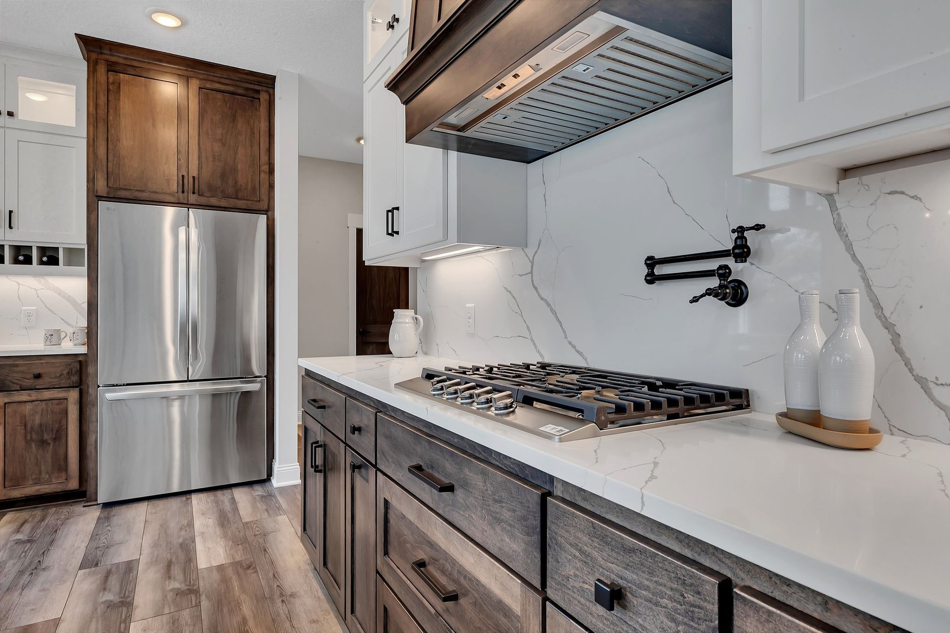 A kitchen with stainless steel appliances and wooden cabinets.