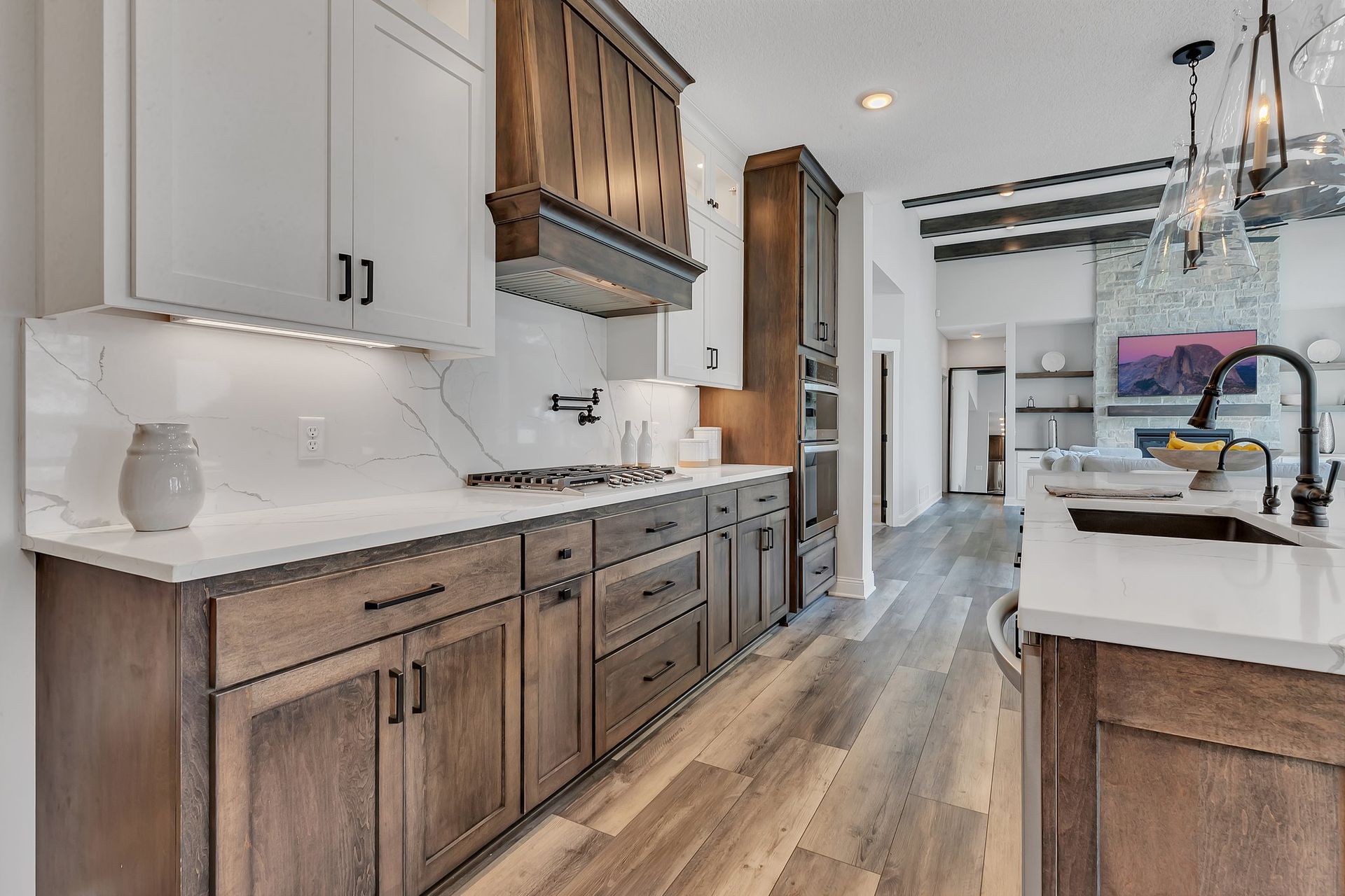 A kitchen with wooden cabinets and white counter tops.