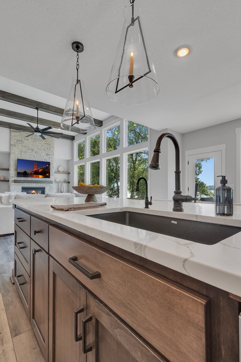 A kitchen with a sink , cabinets , and a faucet.