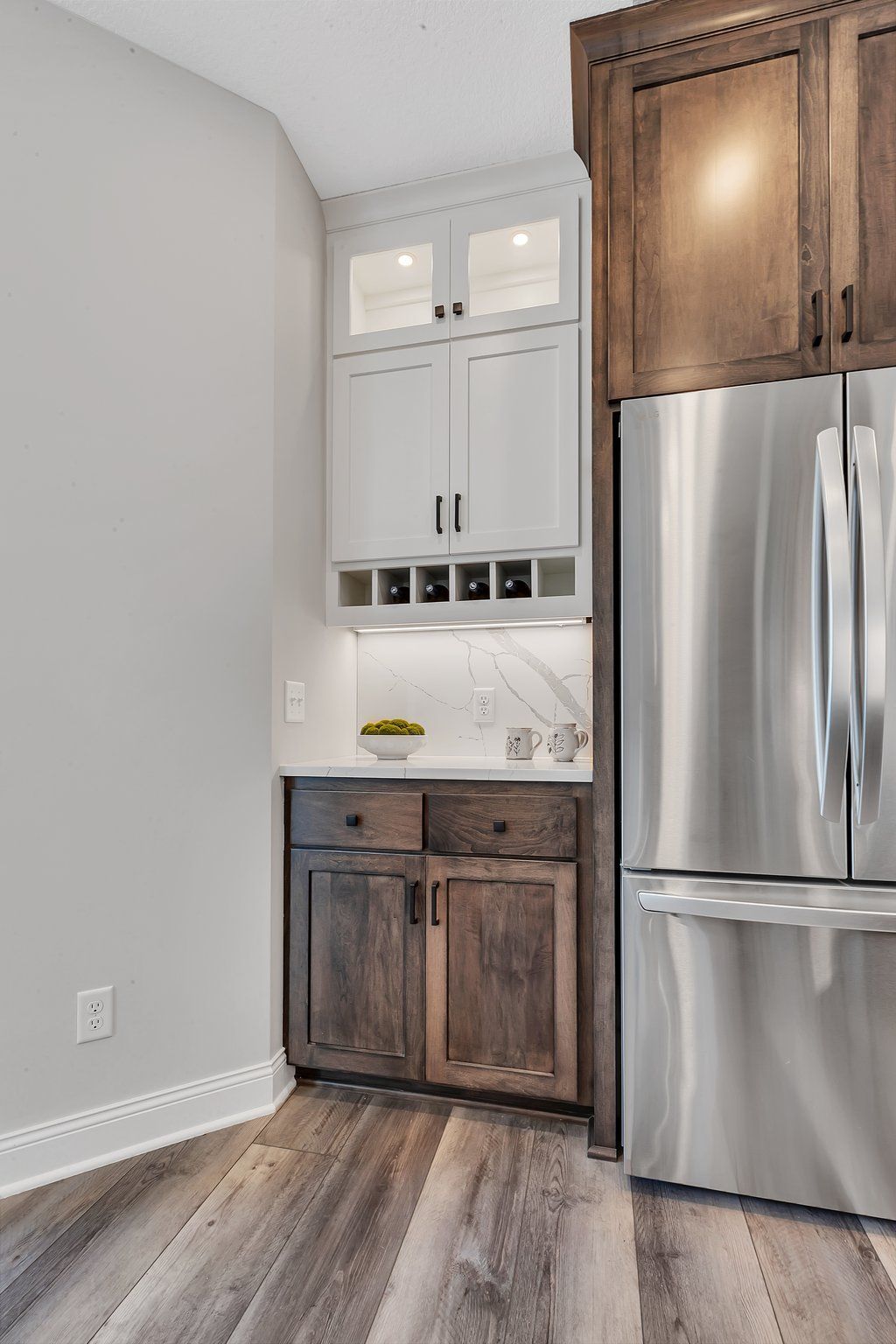 A kitchen with stainless steel appliances and wooden cabinets.