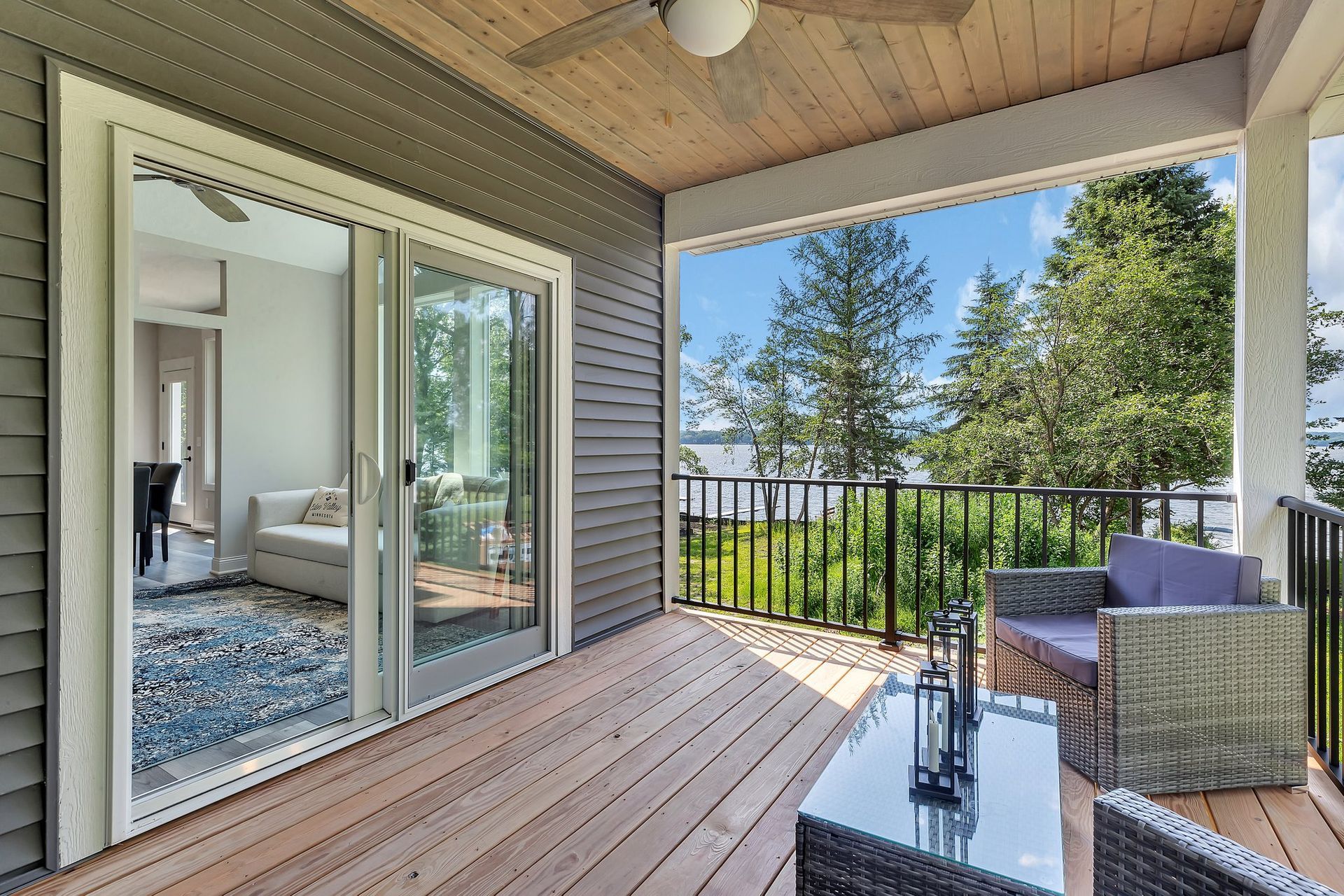 A porch with sliding glass doors and a ceiling fan.