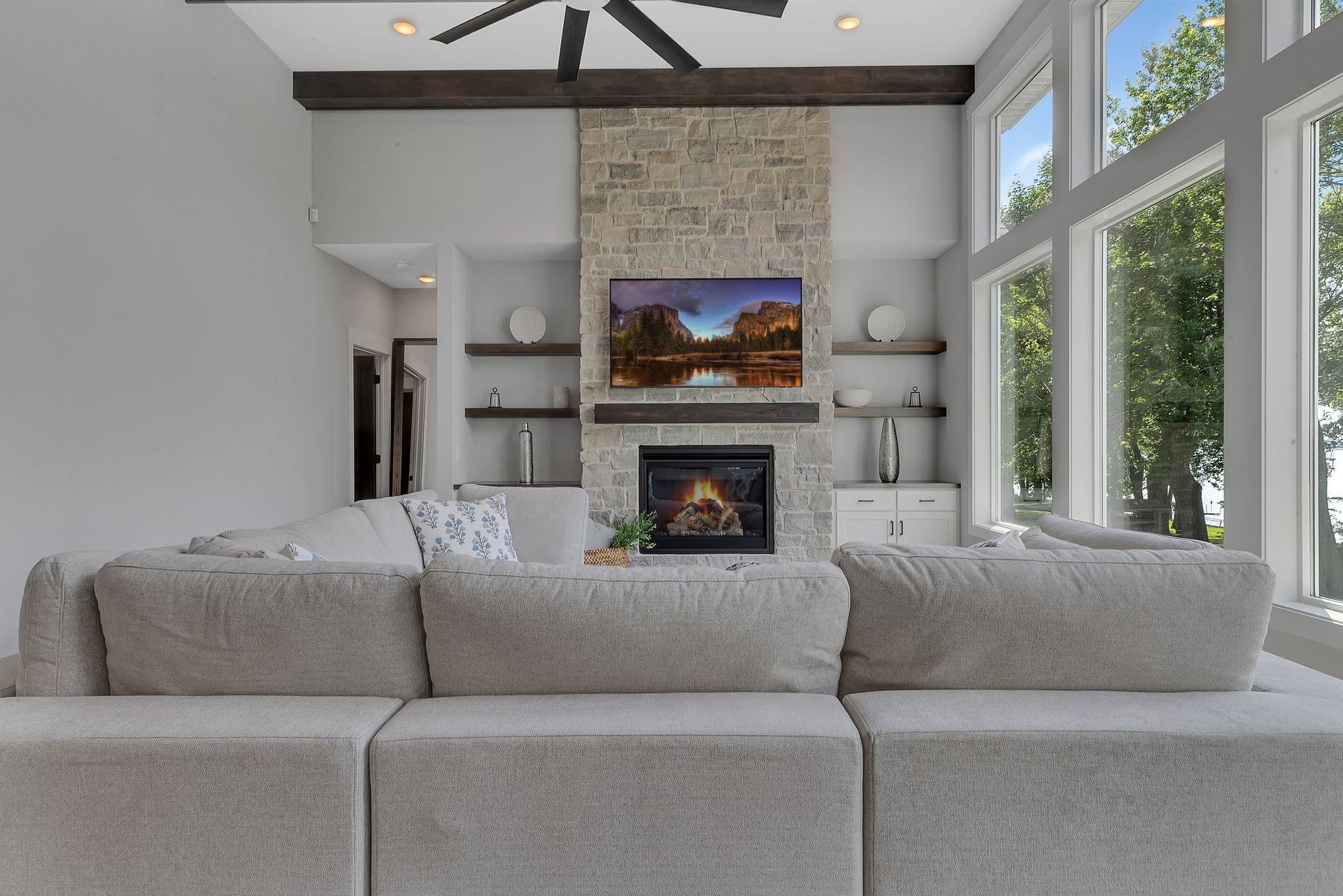 A living room with a couch , fireplace and television