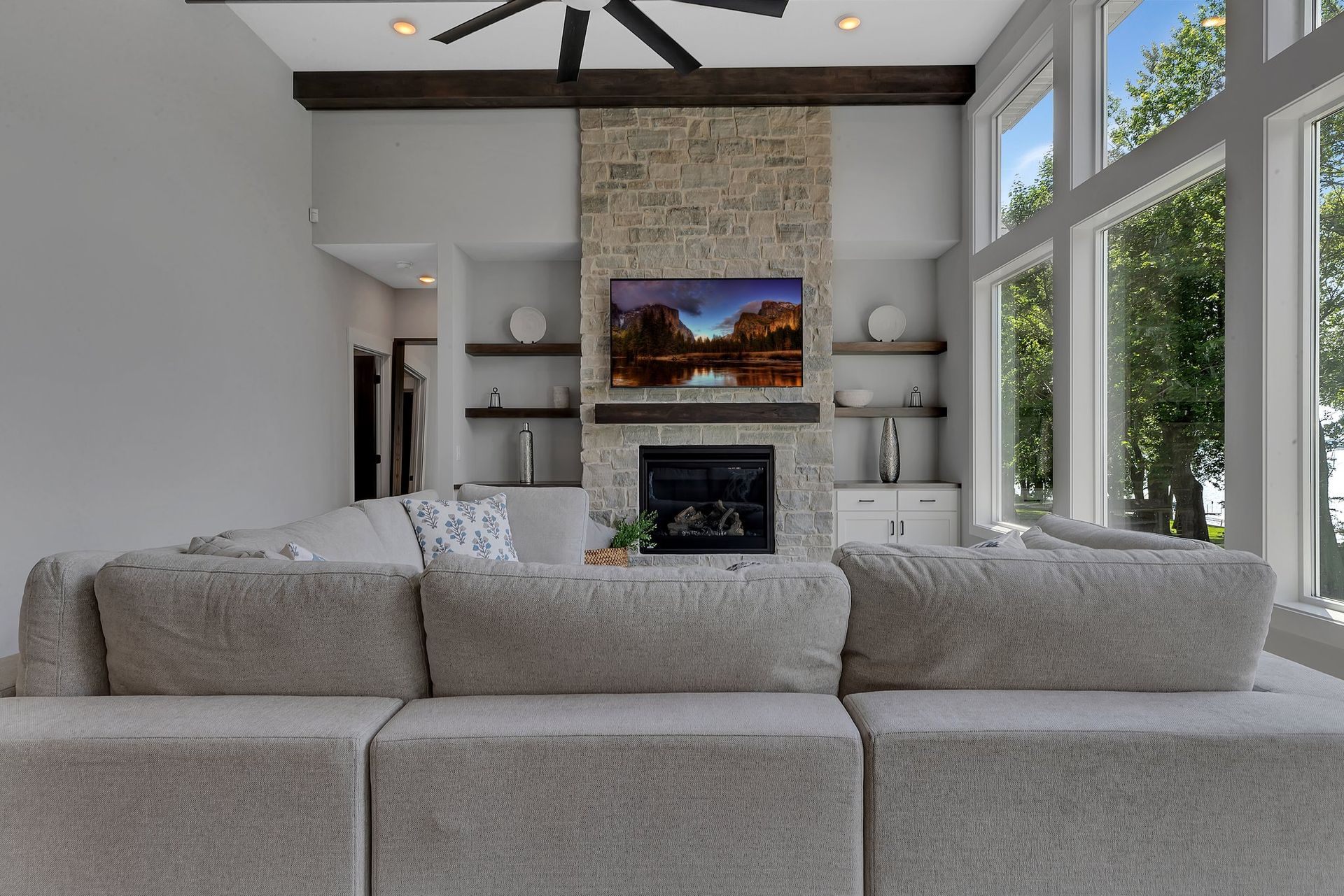 A living room with a couch , fireplace and television.