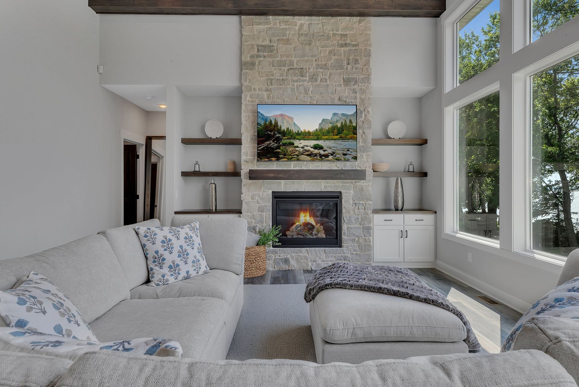 A living room with a couch , fireplace and television.