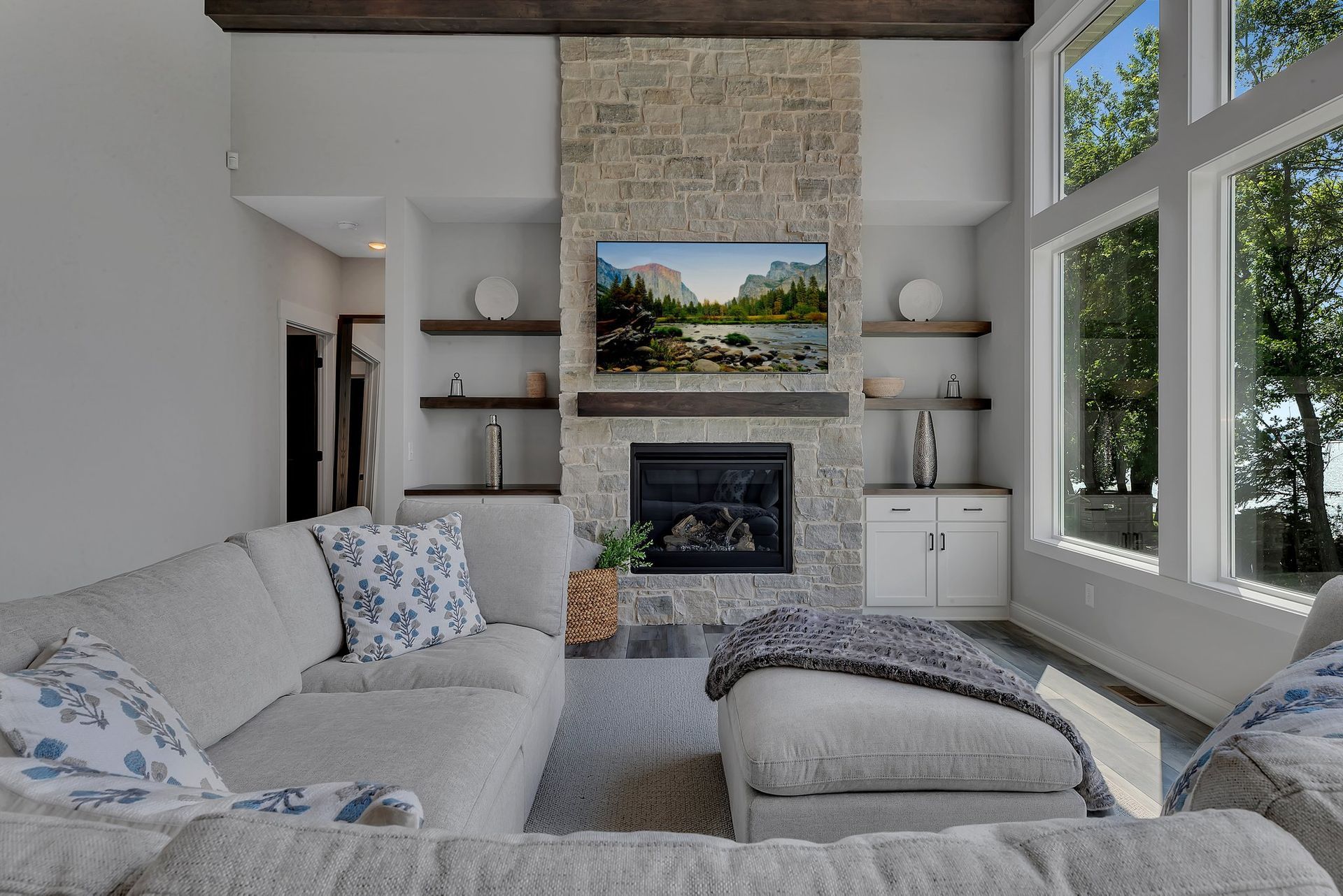 A living room with a couch , fireplace and television.