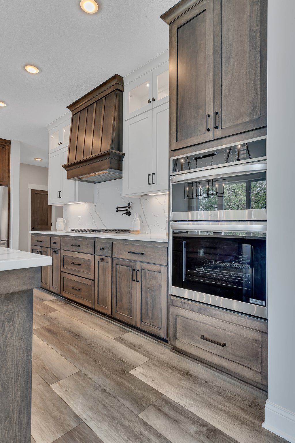 A kitchen with wooden cabinets and stainless steel appliances.