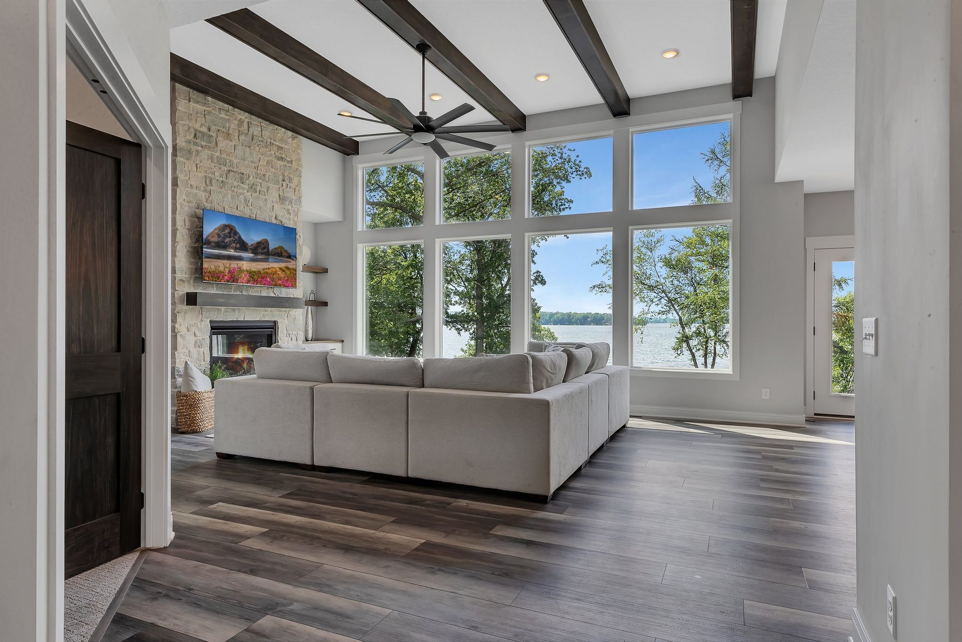 A living room with a large sectional couch and a fireplace.