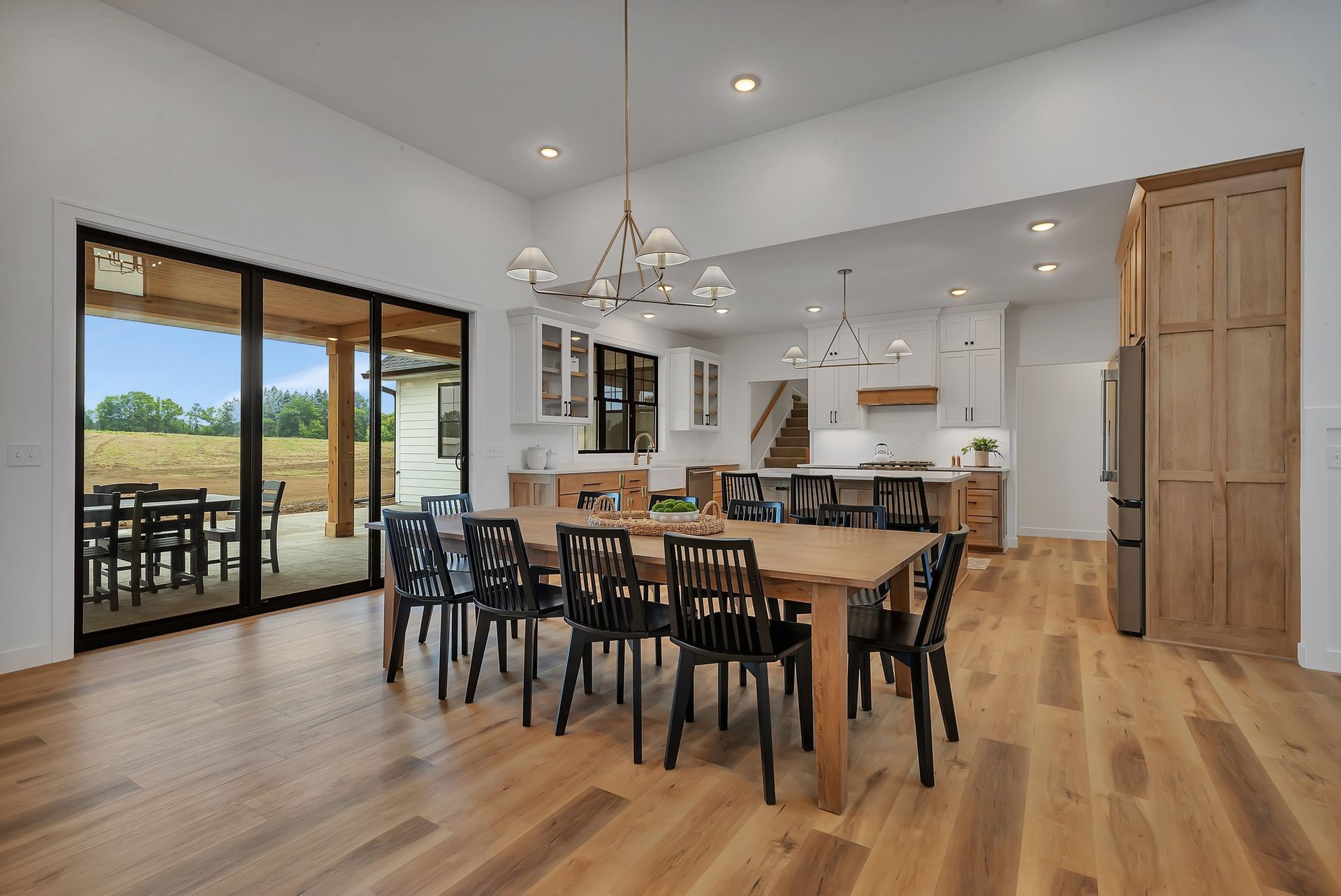 A dining room with a wooden table and chairs in a house.