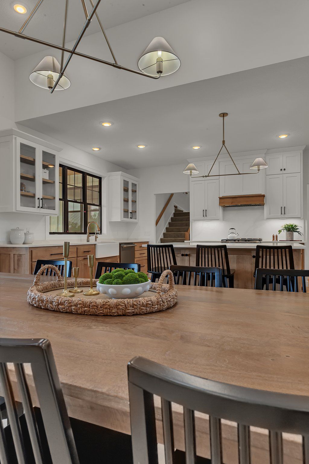 A dining room table with a tray on top of it in a kitchen.