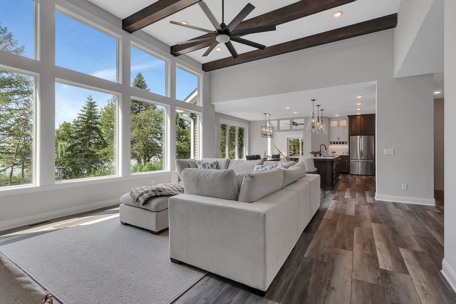 A living room with a couch and a ceiling fan.