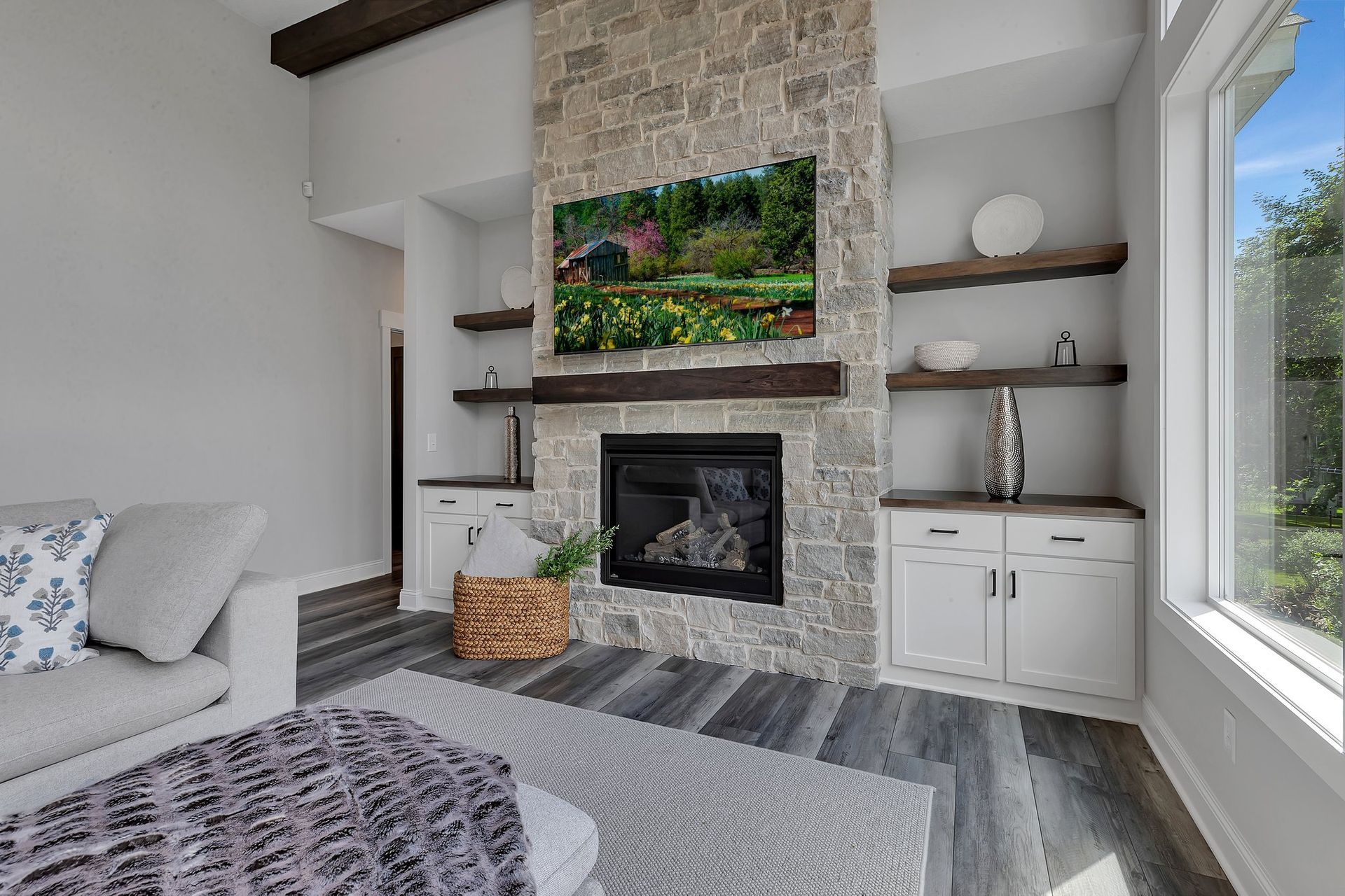 A living room with a fireplace , couch , and television.