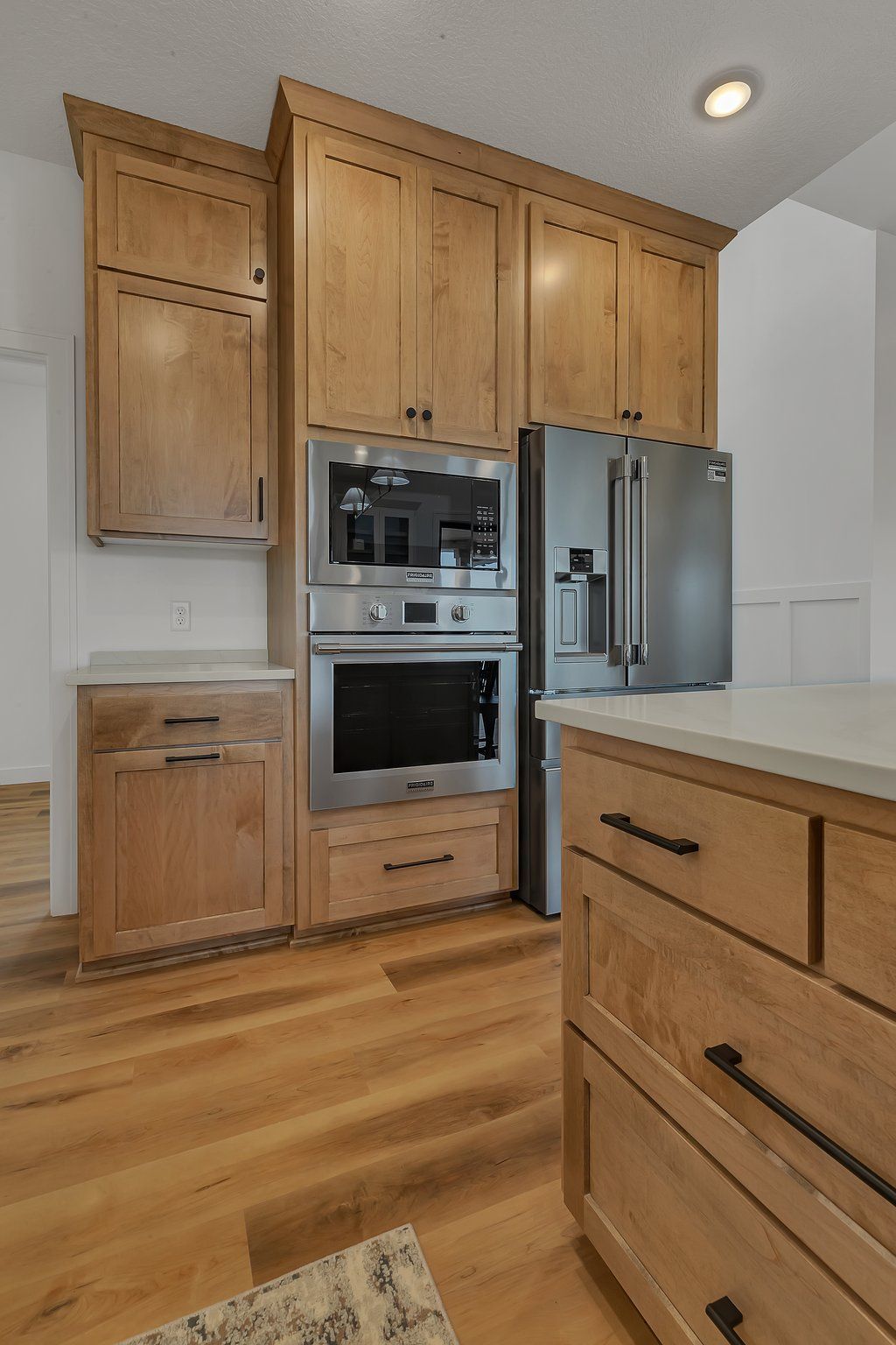 A kitchen with wooden cabinets and stainless steel appliances