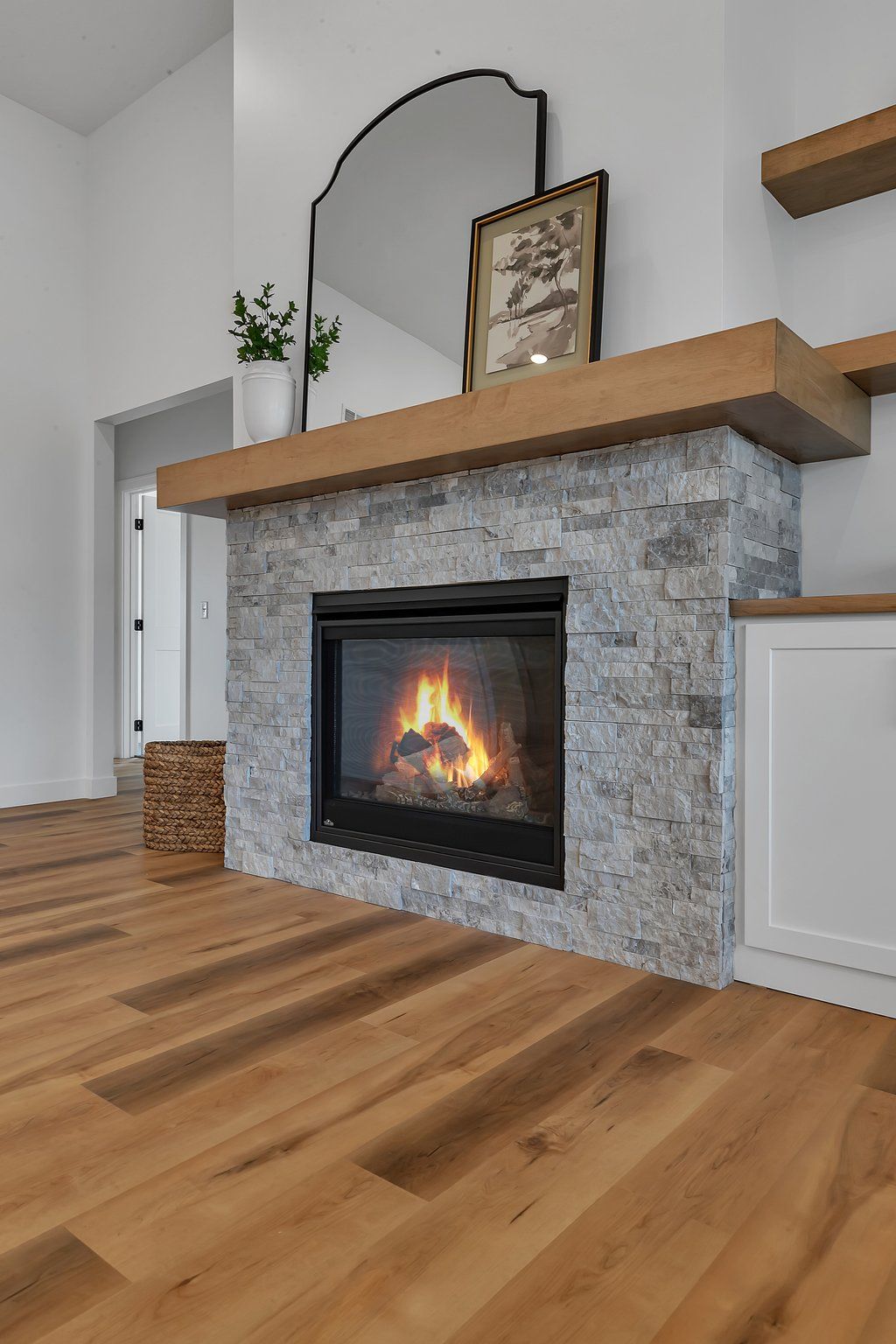 A living room with a fireplace and a mirror.