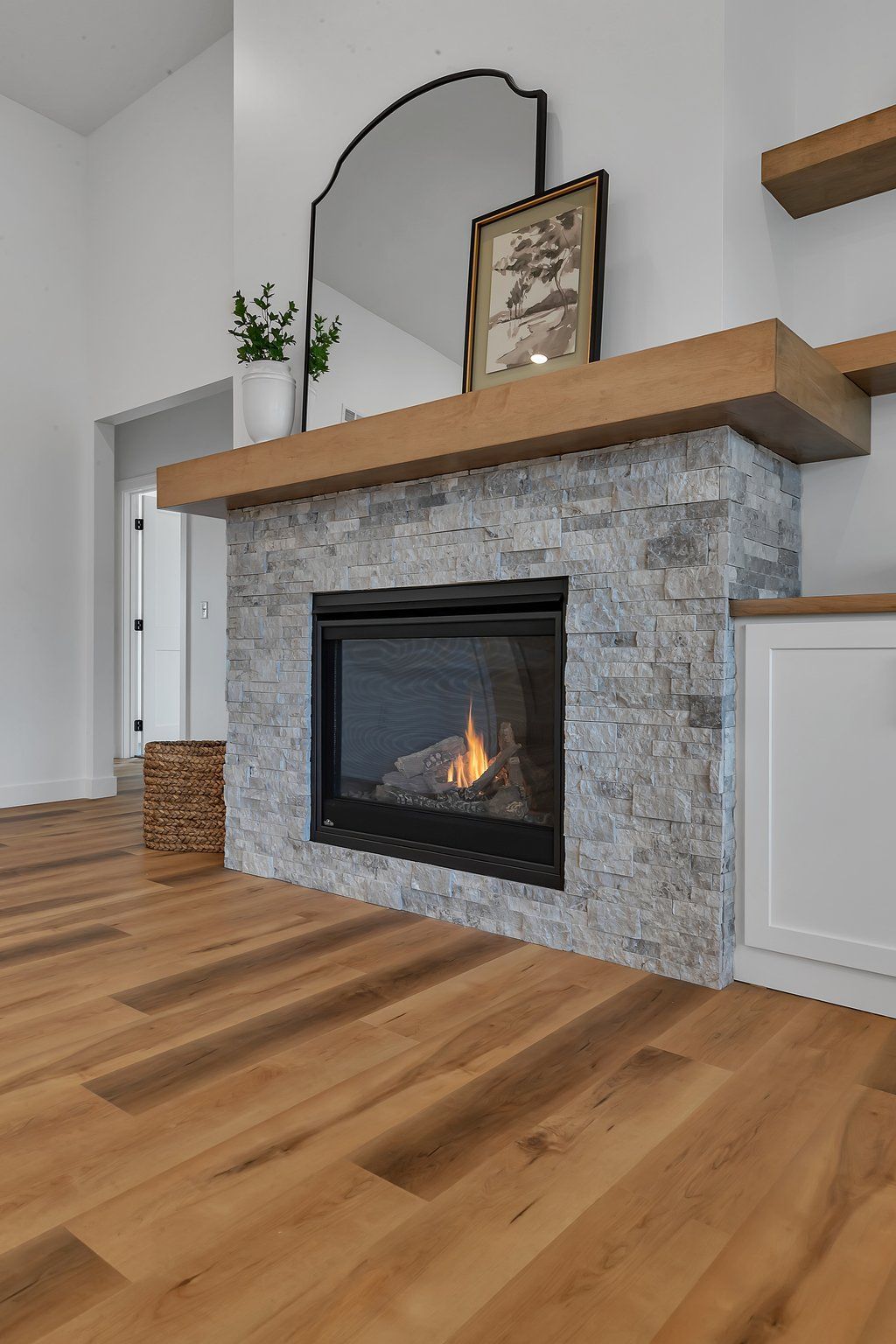 A living room with a fireplace and a mirror.