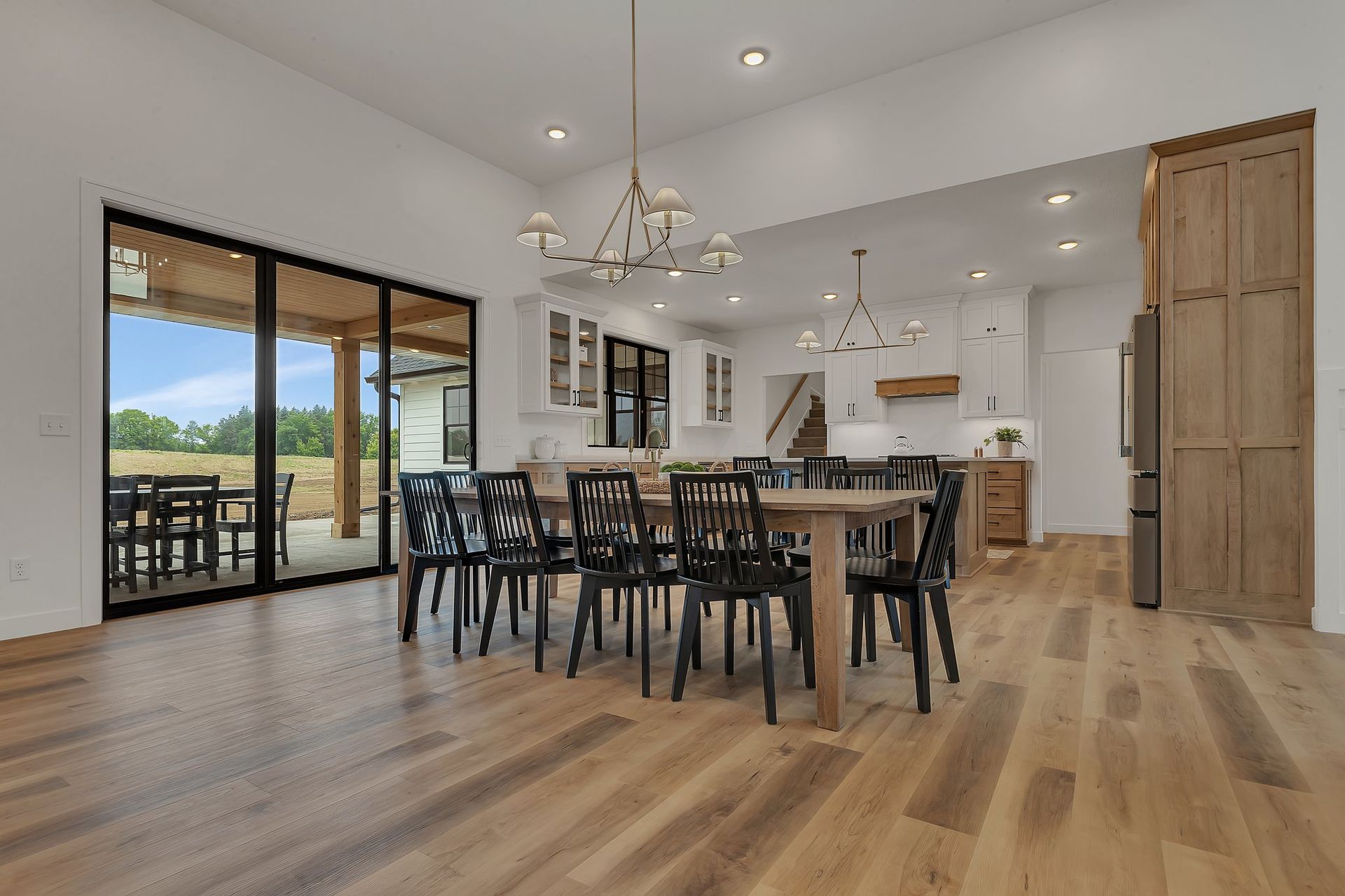 A large dining room with a wooden table and chairs.