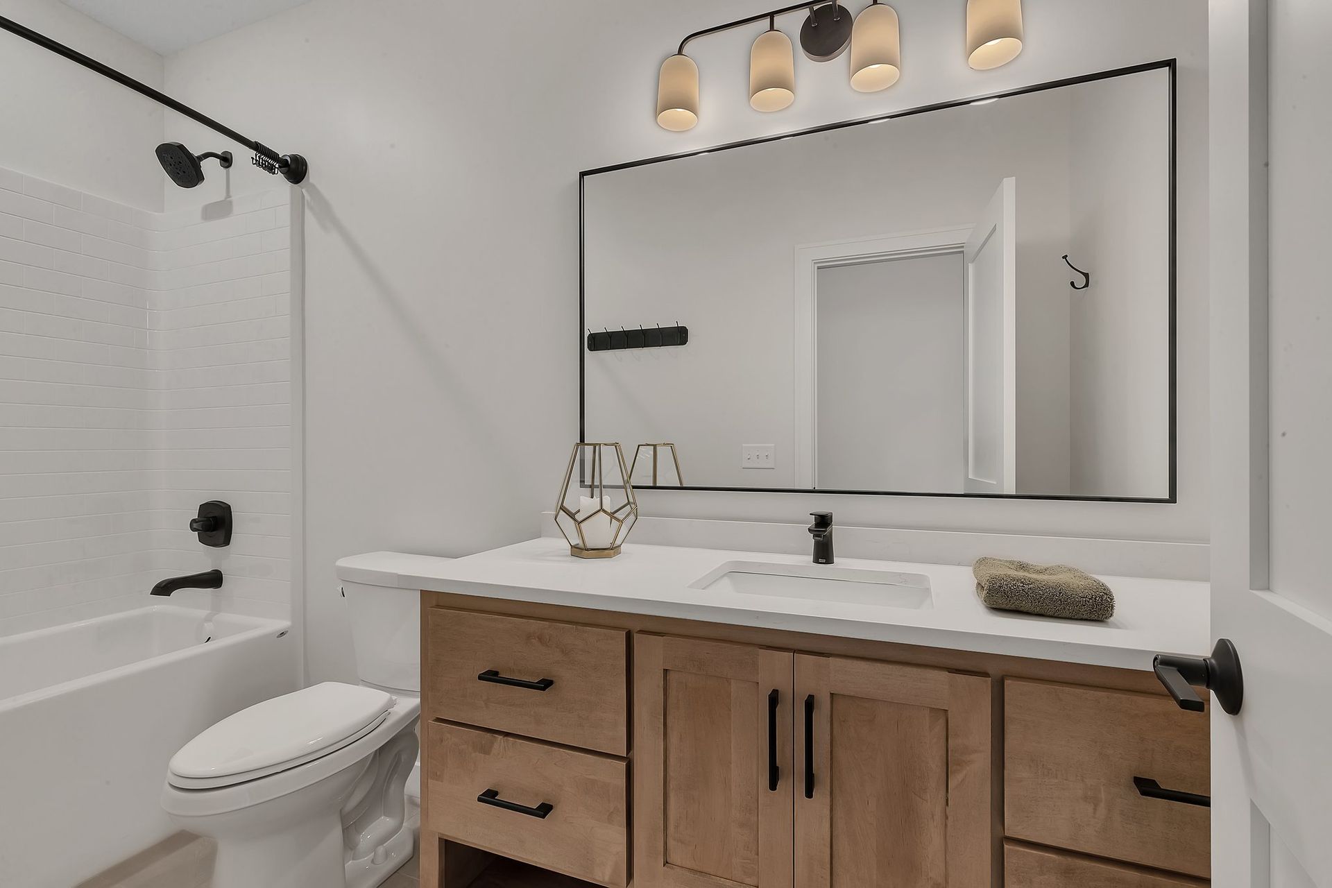 A bathroom with a toilet , sink , and mirror.