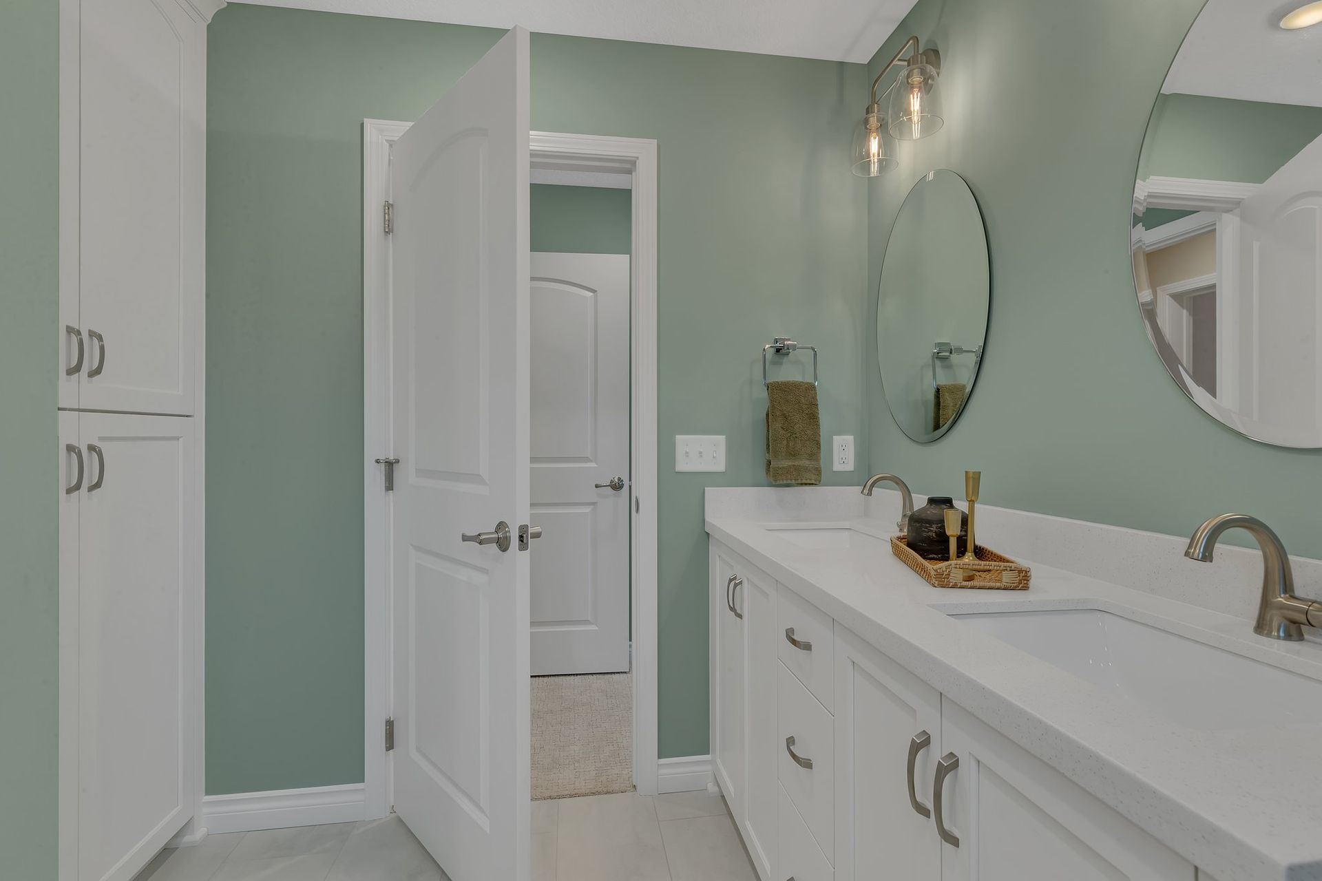 A bathroom with two sinks and a mirror.