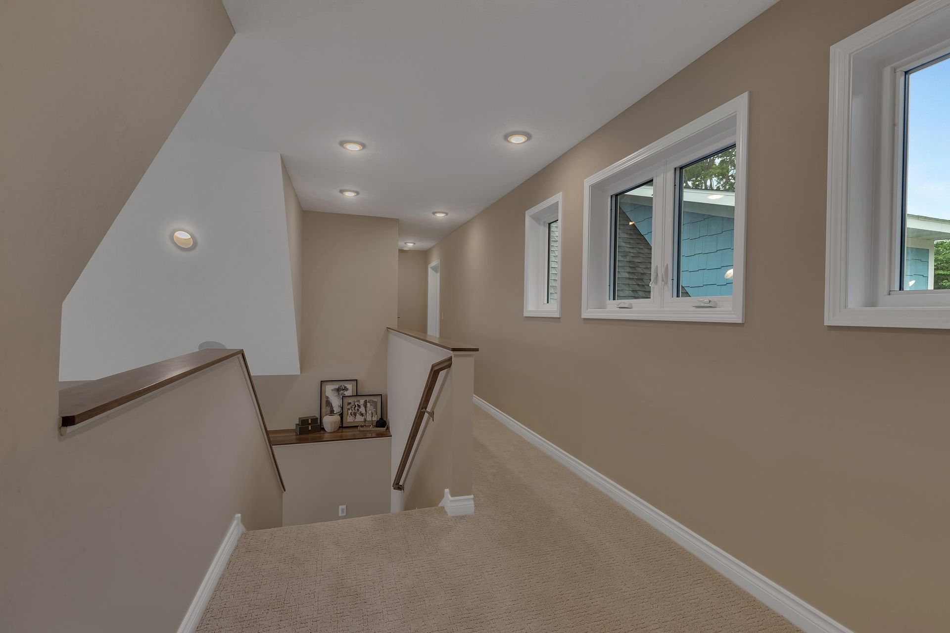 A hallway with stairs leading up to the second floor of a house.