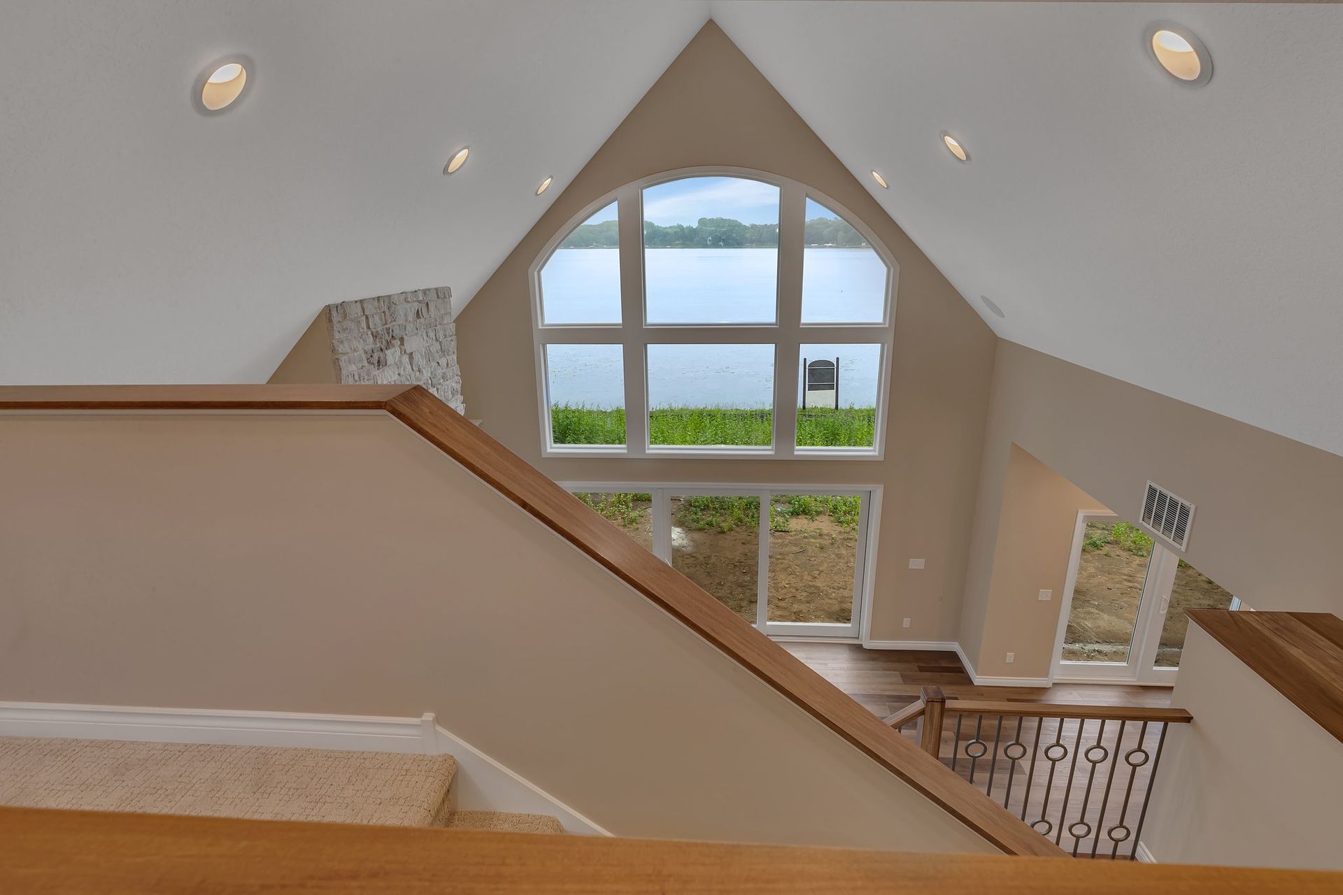 A view of a lake from a staircase in a house