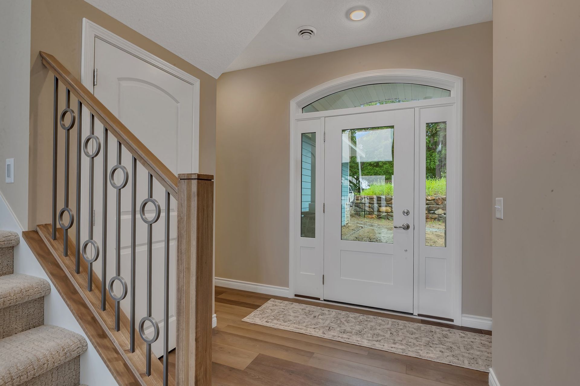 There is a staircase leading up to the front door of a house.