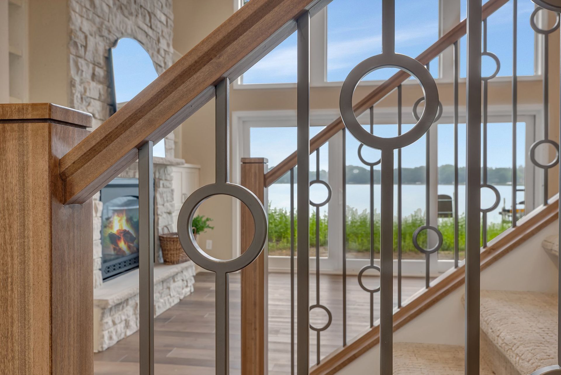 A close up of a wrought iron railing on a staircase in a house.