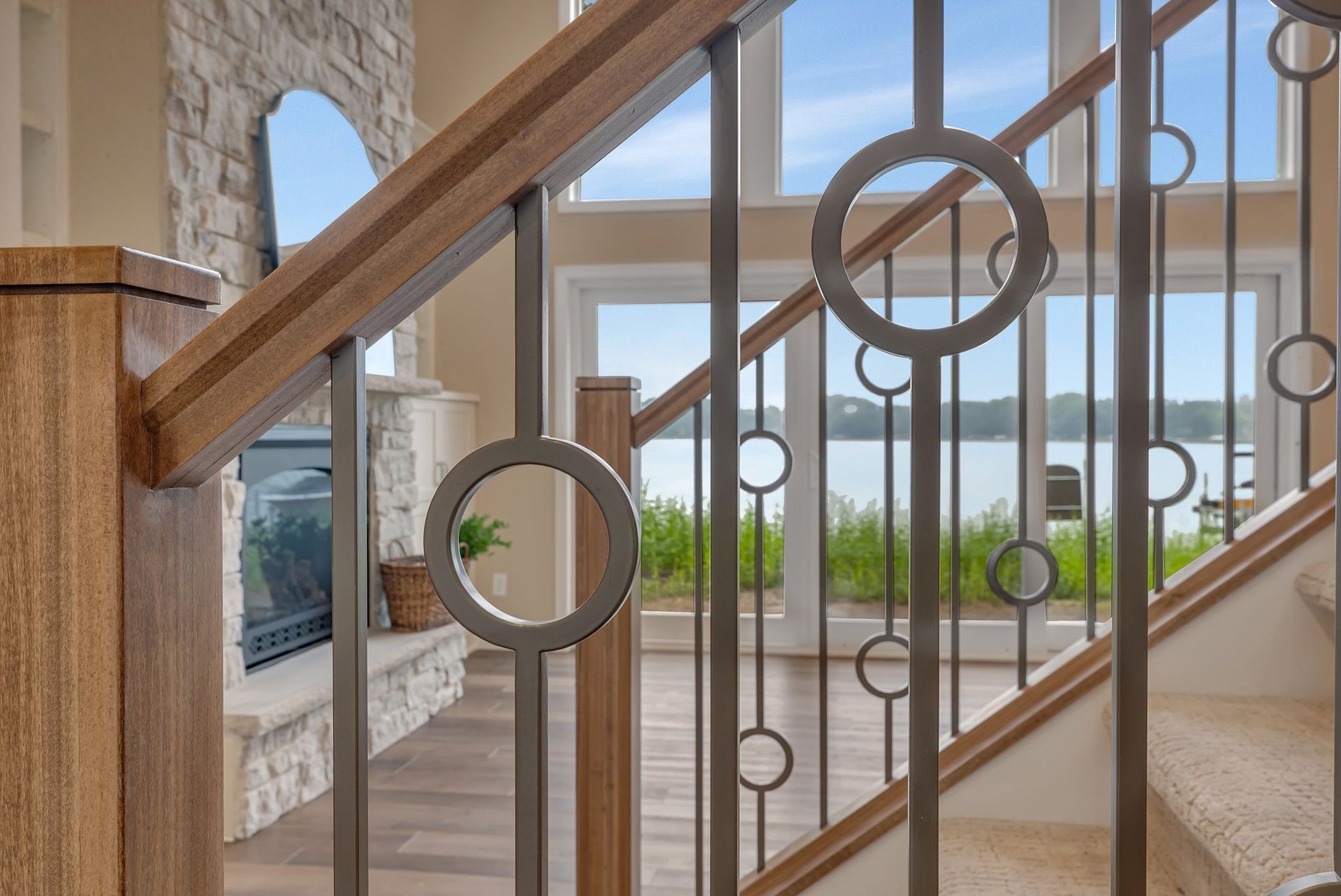 A close up of a wrought iron railing on a staircase in a house.
