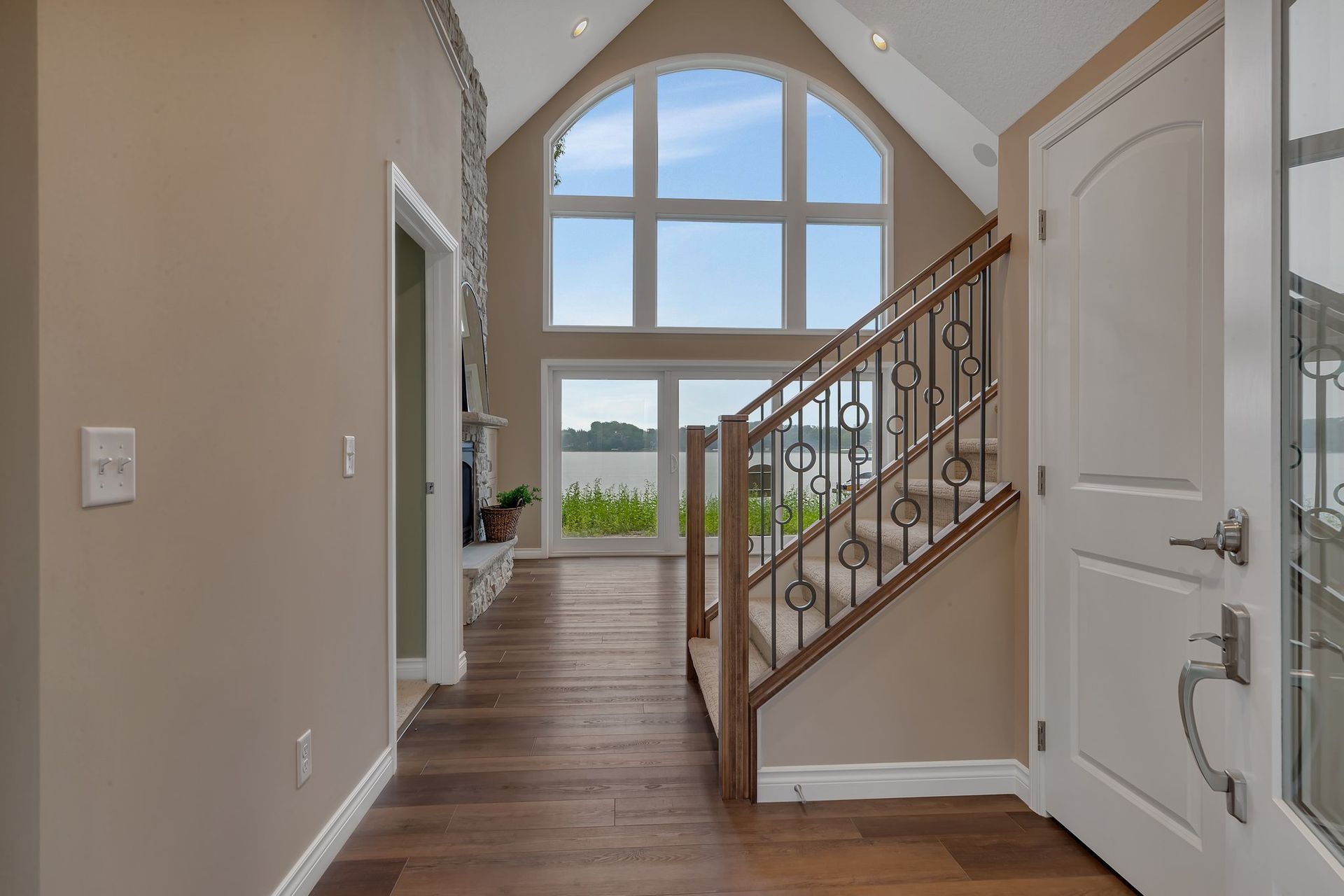 A hallway with stairs leading up to the second floor of a house.
