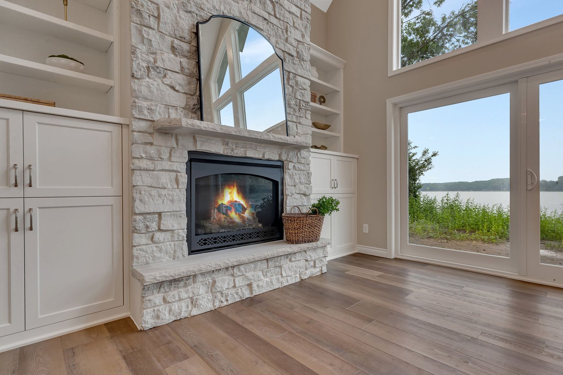 A living room with a fireplace and sliding glass doors.