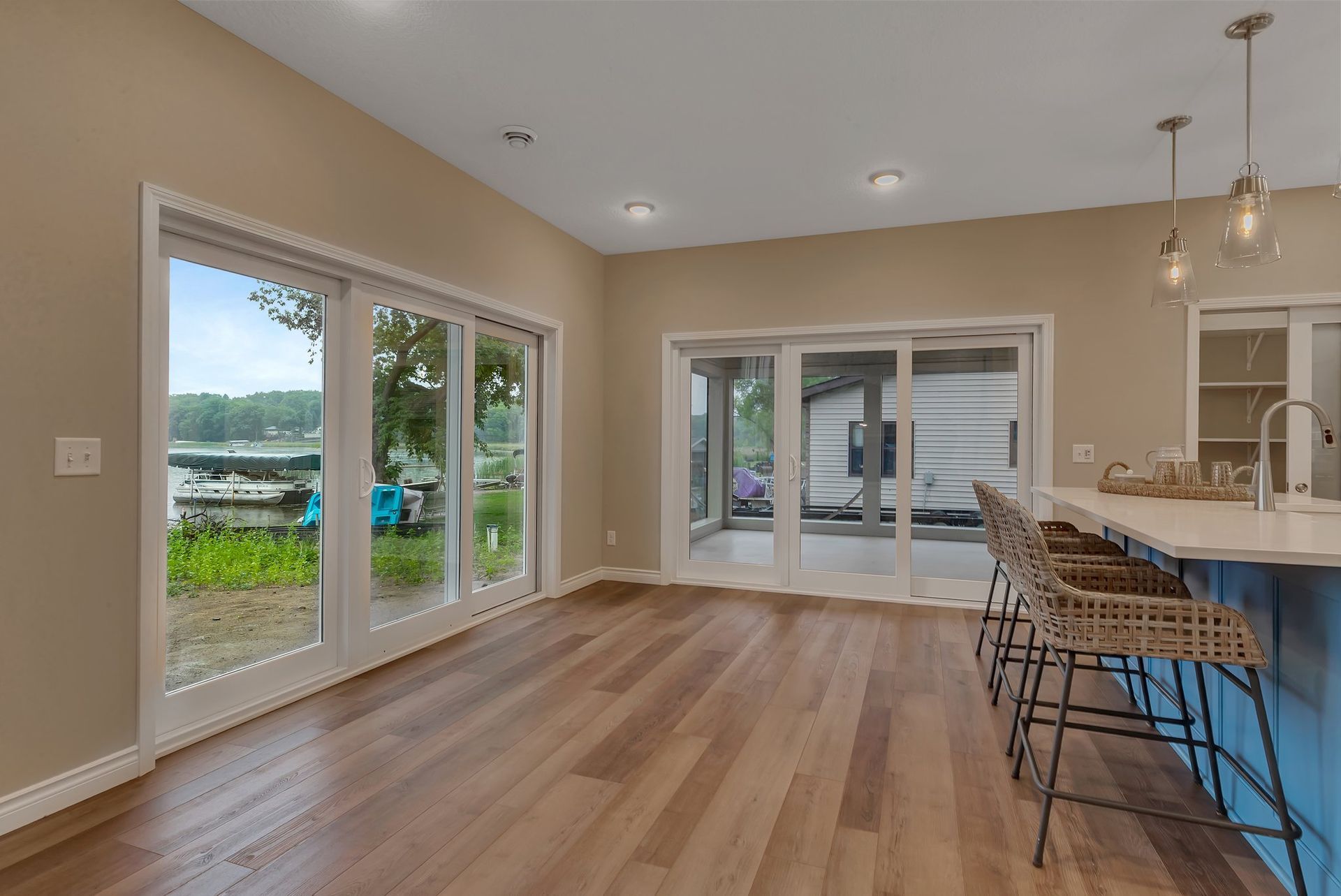 A living room with hardwood floors and sliding glass doors leading to a patio.