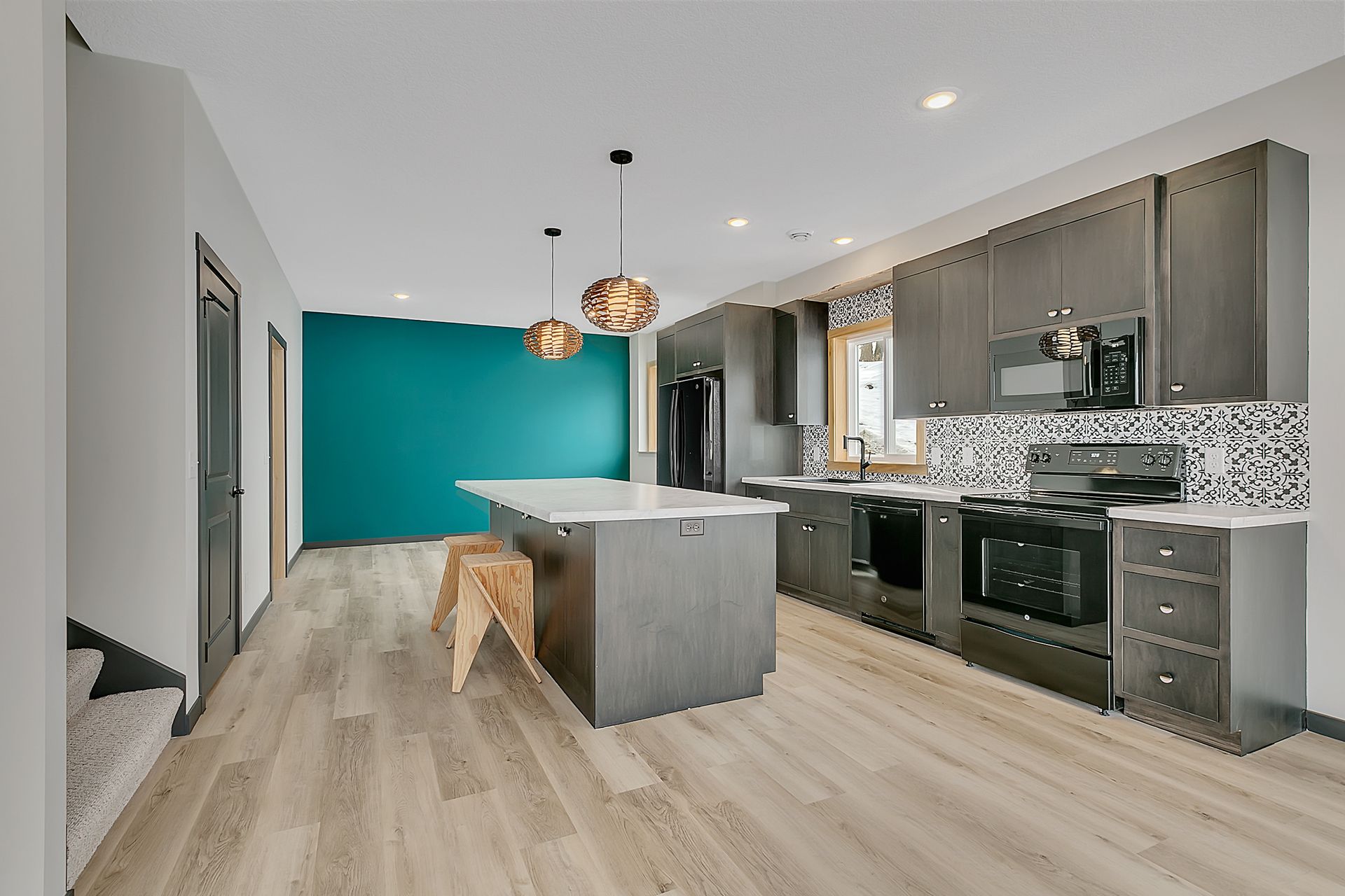 A kitchen with a large island and stainless steel appliances.