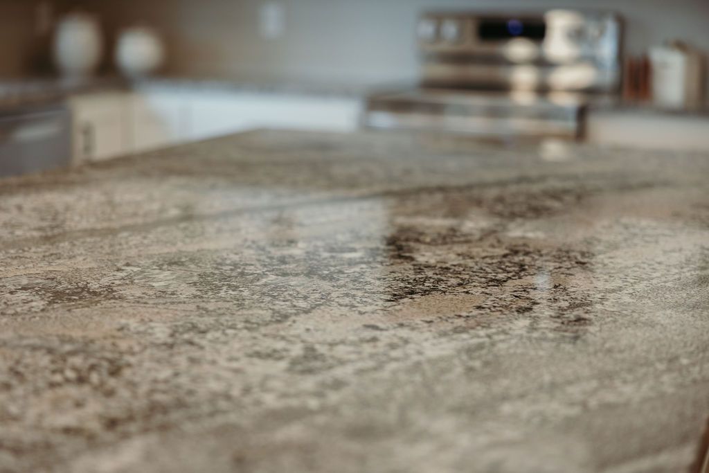 Close-up of a mottled, textured countertop in a kitchen.