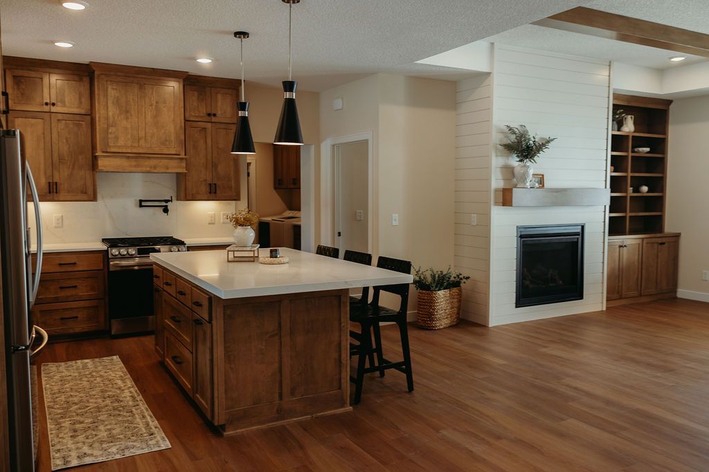 Kitchen with island, fireplace, and built-in shelving.  