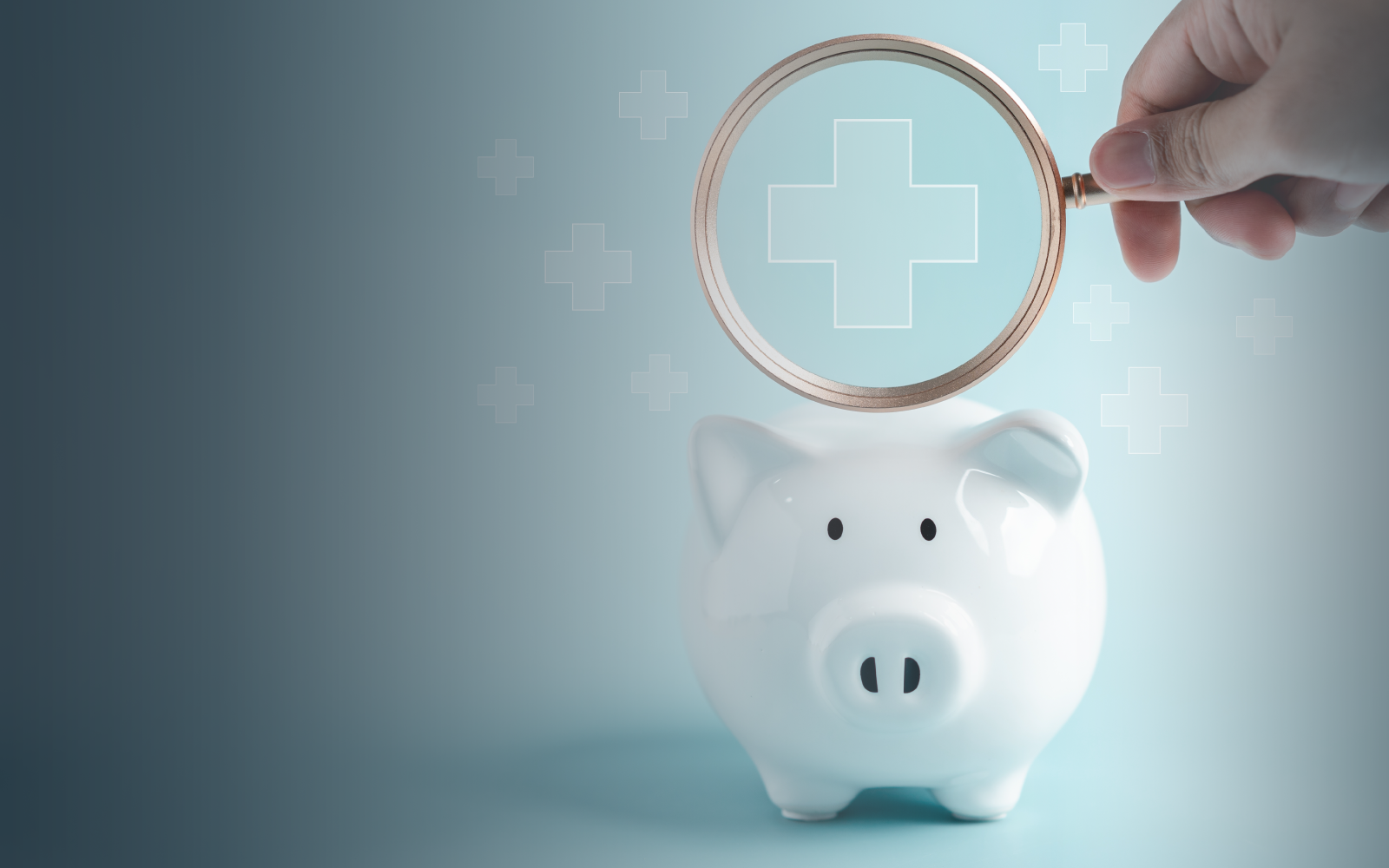 A hand holds a magnifying glass over a white piggy bank, highlighting a glowing medical plus sign symbol.