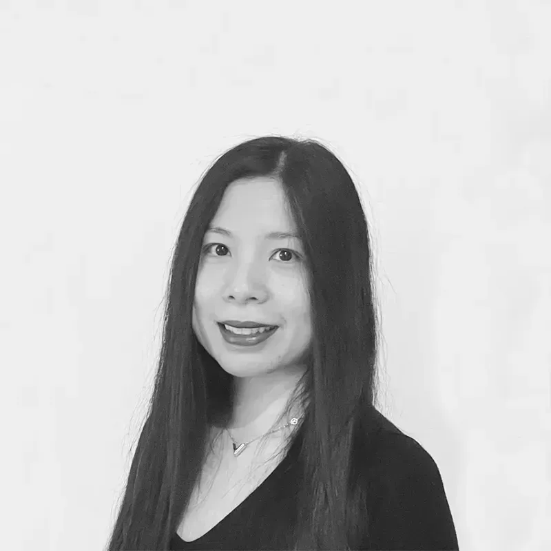 A black and white photo of a woman with long hair and a necklace.
