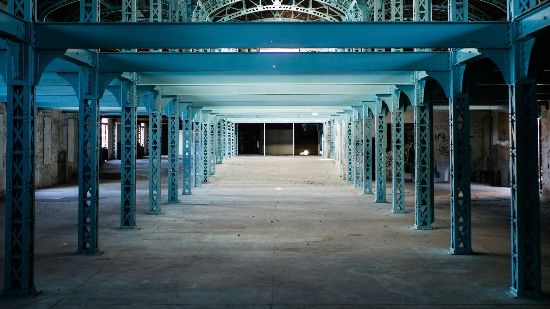 An empty building with blue columns and a blue ceiling