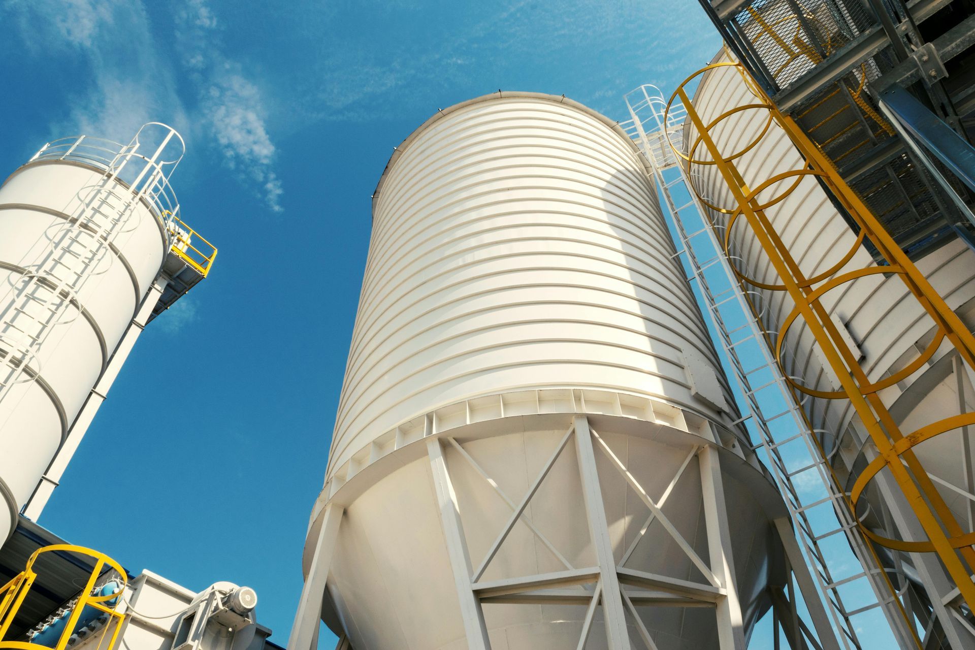 Looking up at a factory with a blue sky in the background