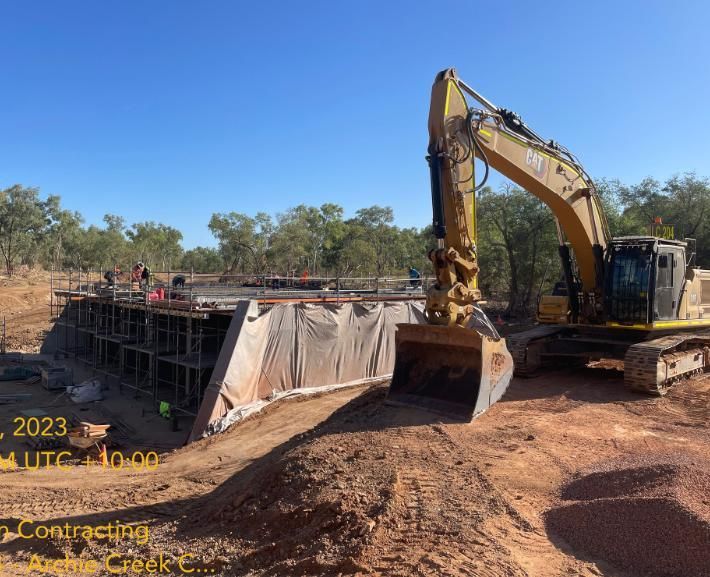A Large Yellow Excavator is Working on a Construction Site — Lohman Contracting in Emerald, QLD